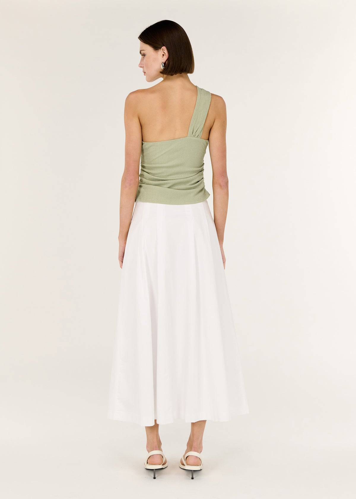 Back view of the Sage One Shoulder Knotted Top with a one-shoulder asymmetrical design and a soft twist detail at neckline.