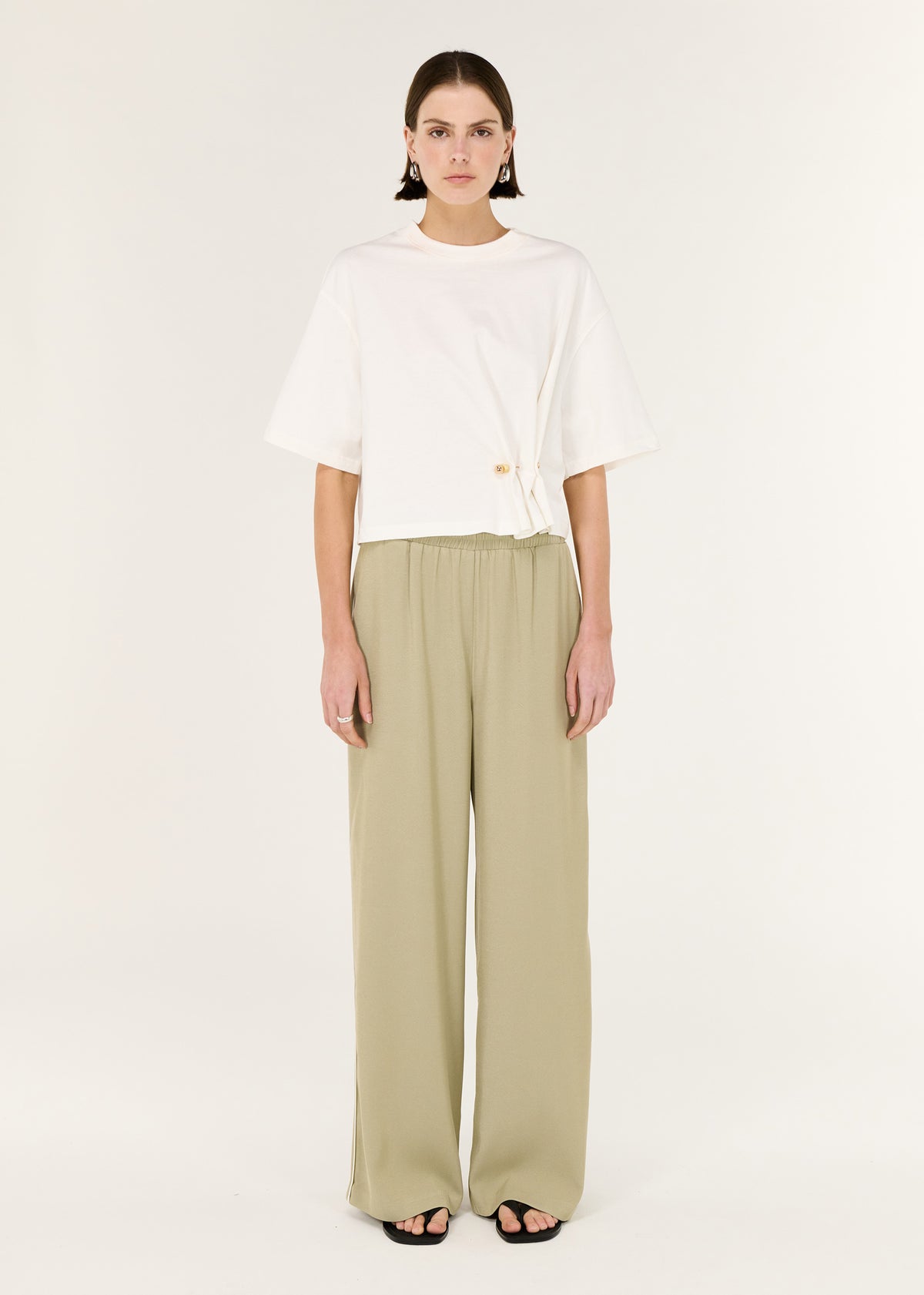 Model wearing Sage Relaxed Track Pant with a contrast side stripe detailing and a lightweight, fluid fabrication.