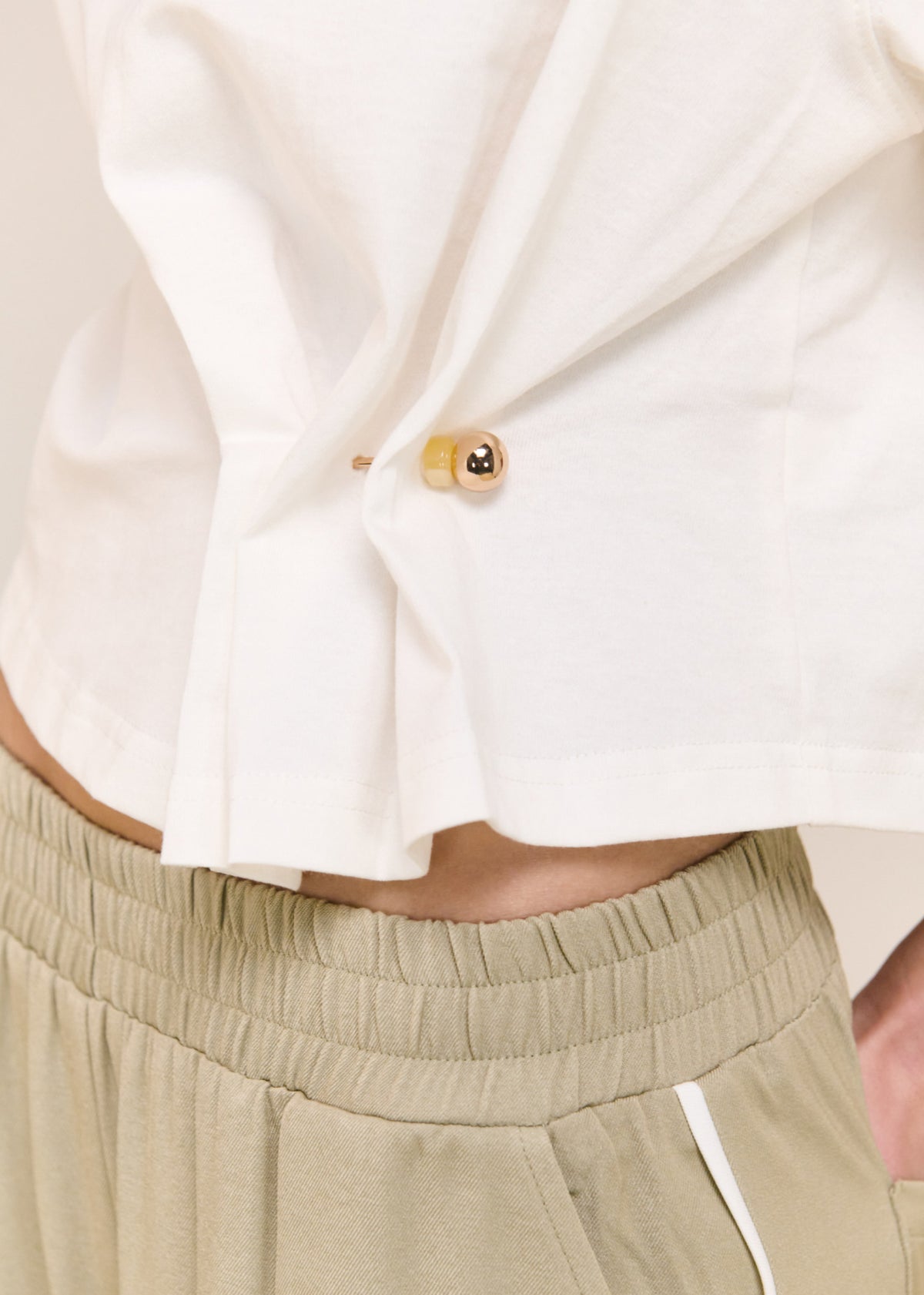 Close-up detail of the Sage Relaxed Track Pant, showing waistband and button.