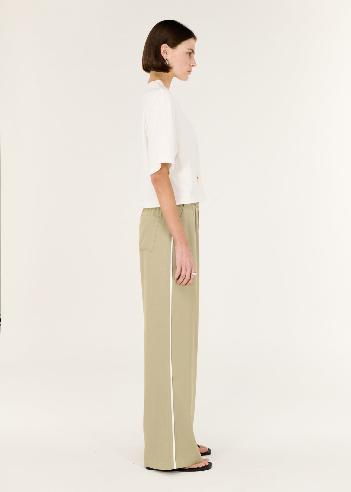 Side view of the Sage Relaxed Track Pant, showing a relaxed wide-leg silhouette and an elasticated waistband.