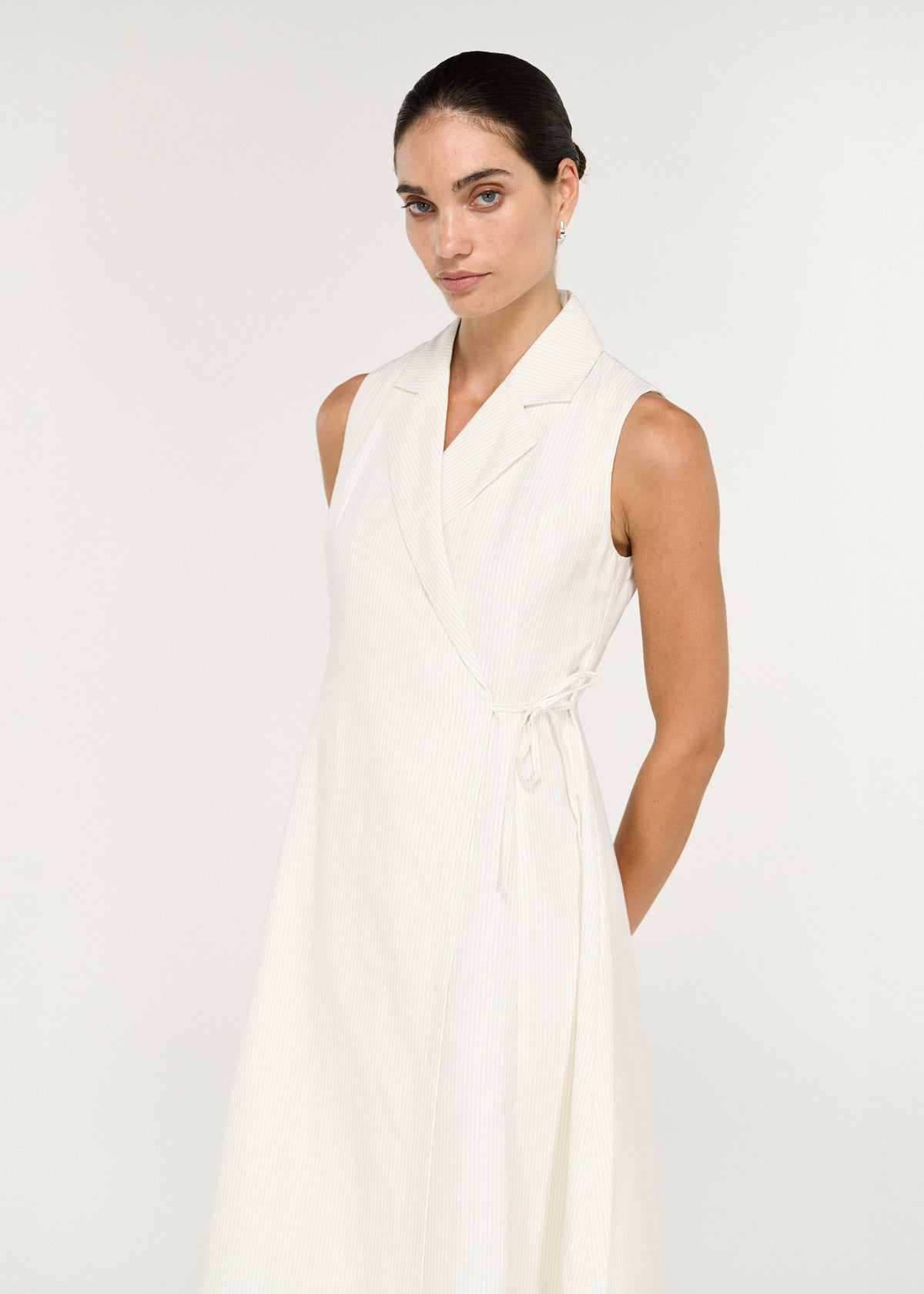 Cotton Blend Wrap Detail Midi Dress featuring a sleeveless silhouette and collared wrap front with adjustable side tie.