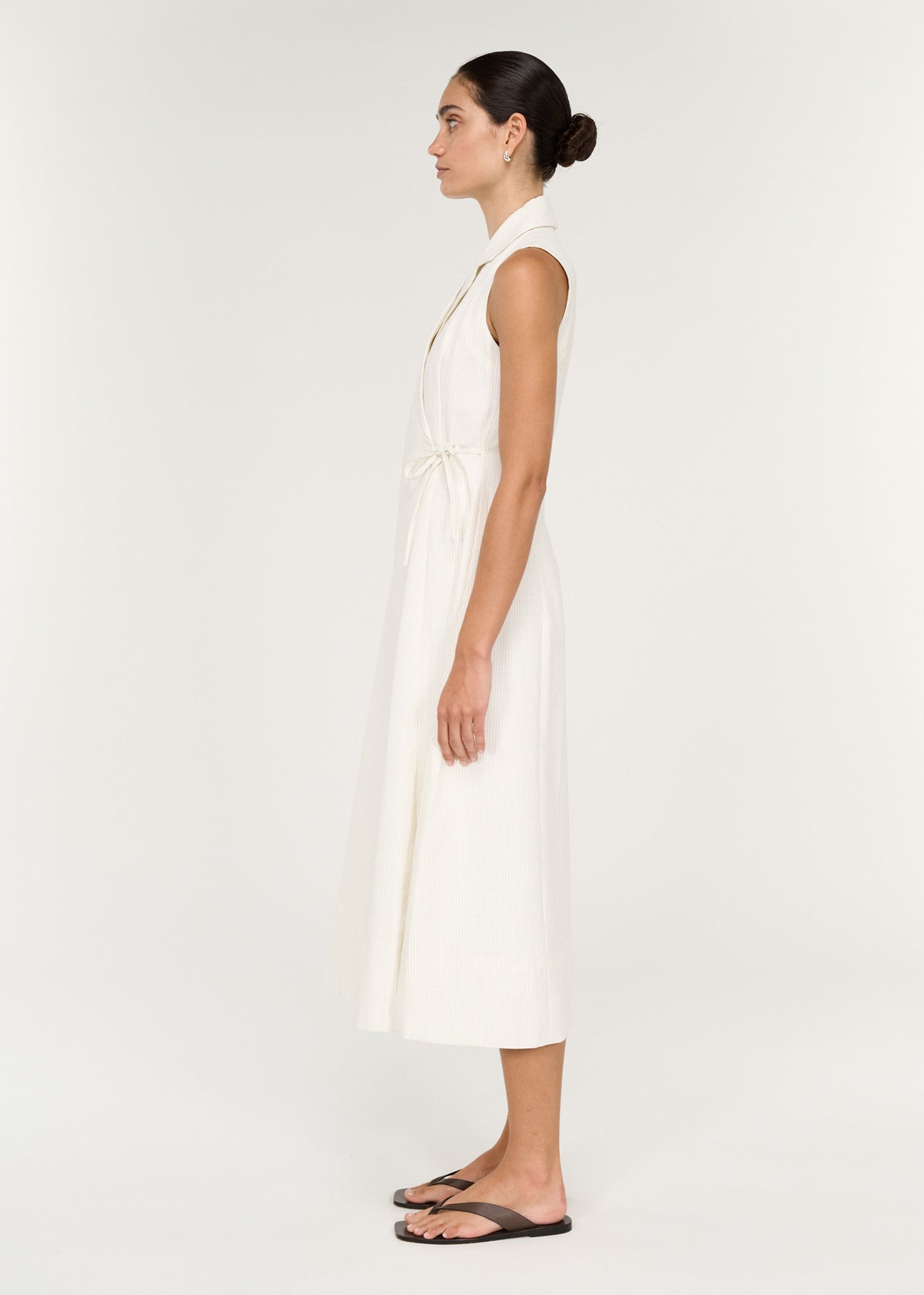 Side view of a model wearing a Cotton Blend Wrap Detail Midi Dress with a collar and adjustable tie.