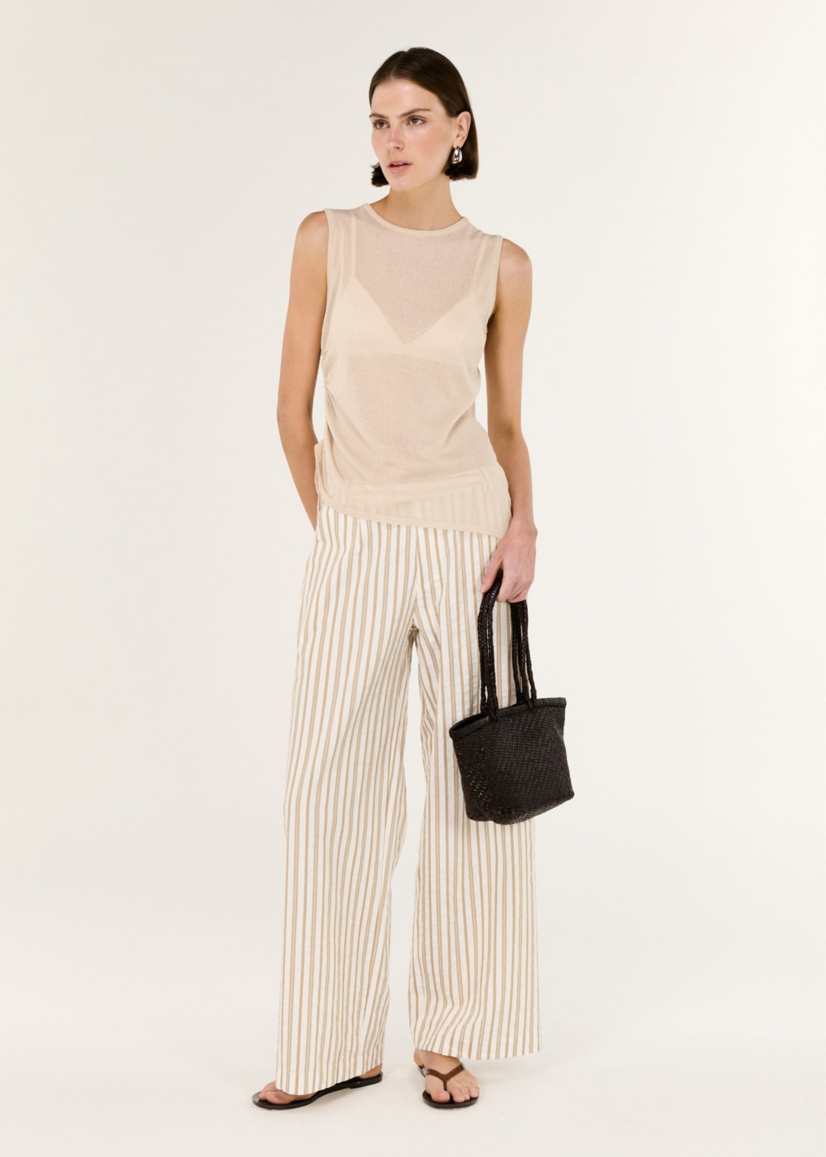 Model wearing Sheer Drawstring Knit Tank Top with a soft ruching through the waist and a lightweight, semi-sheer knit finish.