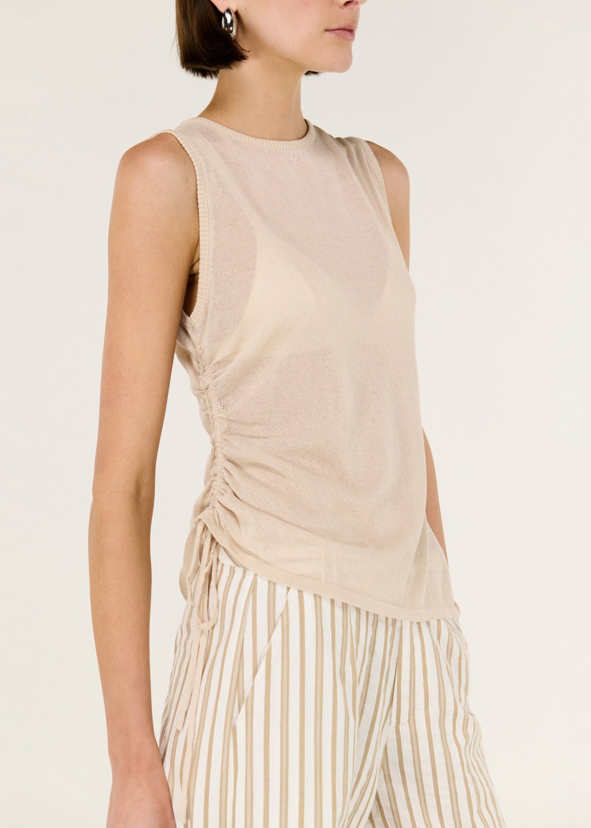 Close-up detail of the Sheer Drawstring Knit Tank Top, showing ruched side.