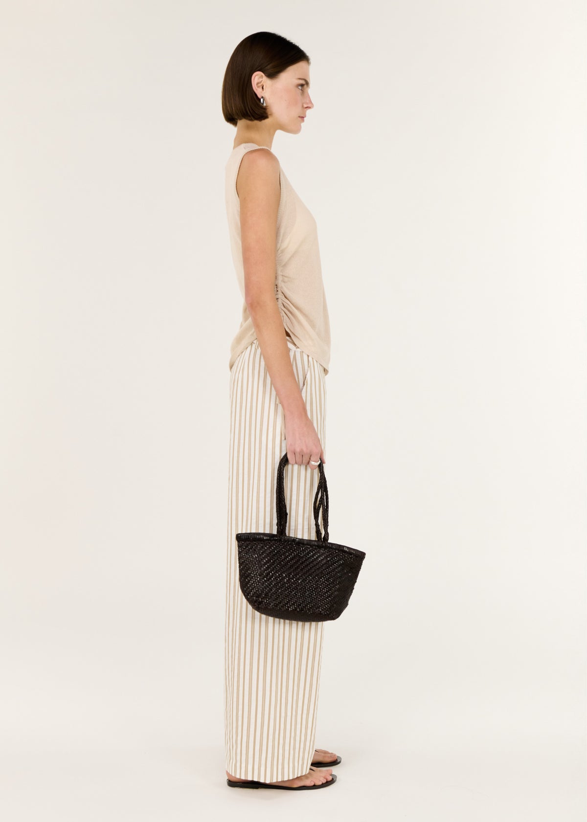 Side view of the Sheer Drawstring Knit Tank Top, showing an adjustable side drawstring detail and a soft ruching through the waist.