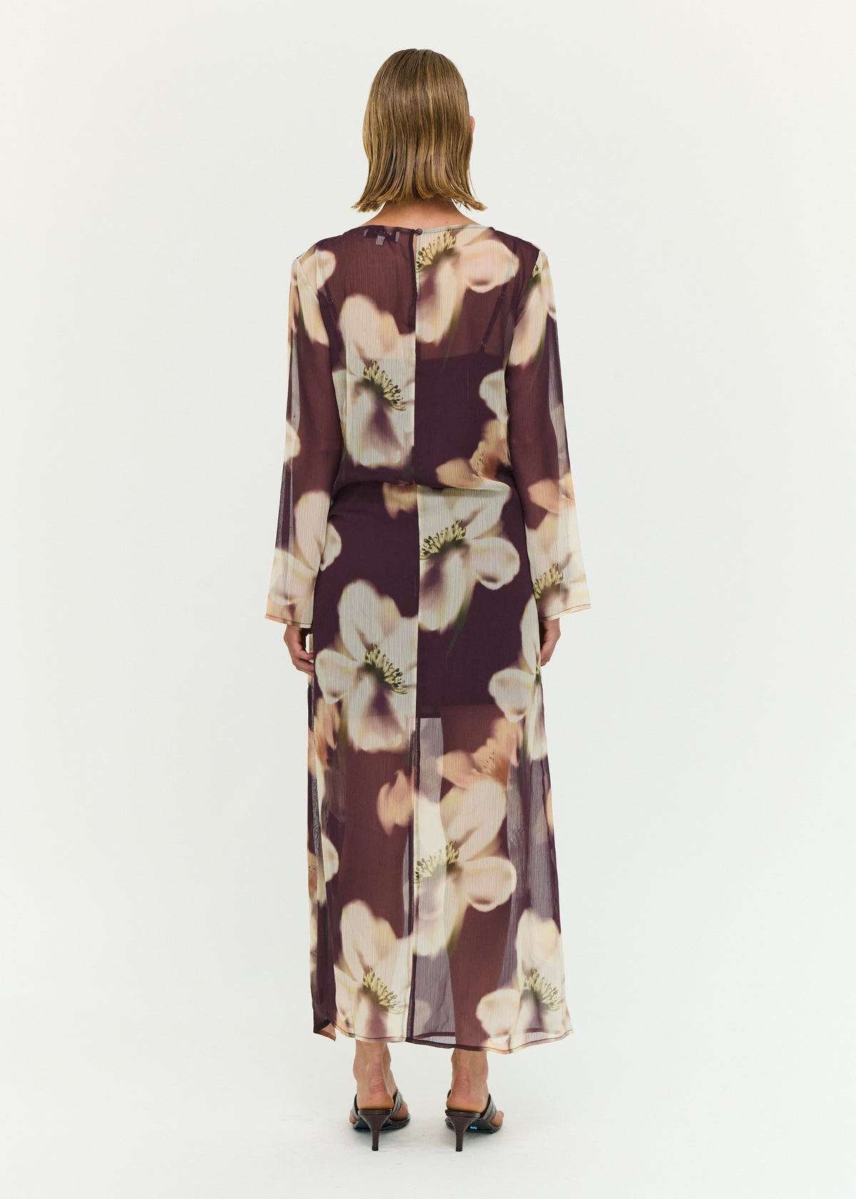 Back view of the Sheer Floral Maxi Dress with Tie Detail with a wrap-style waist with adjustable tie detail and a sheer mesh fabrication.