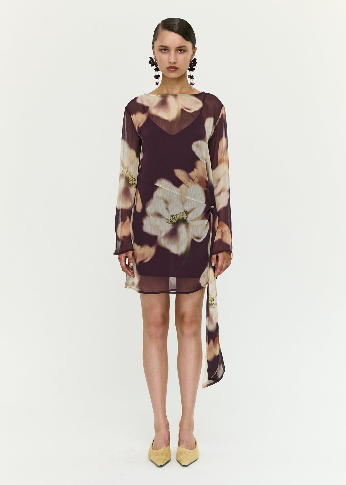 Model wearing Sheer Floral Mini Dress with Tie Detail with a polyester fabrication.