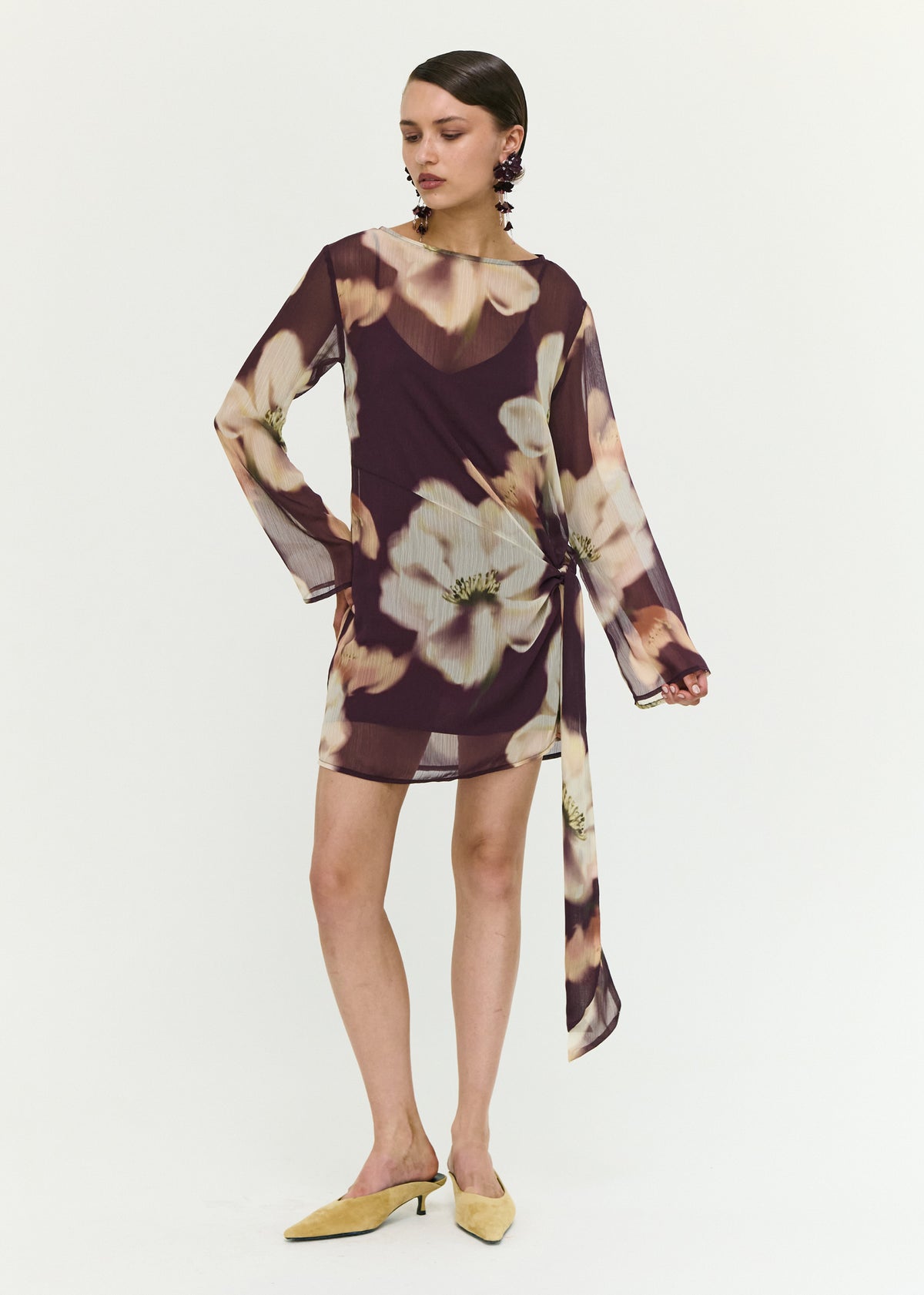 Model wearing Sheer Floral Mini Dress with Tie Detail with a polyester fabrication (front full body).