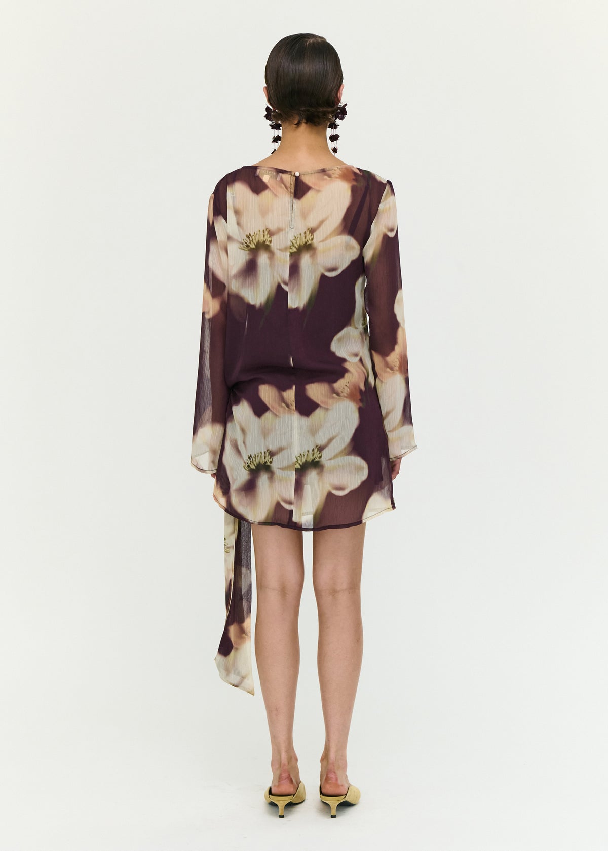 Back view of the Sheer Floral Mini Dress with Tie Detail with a polyester fabrication.
