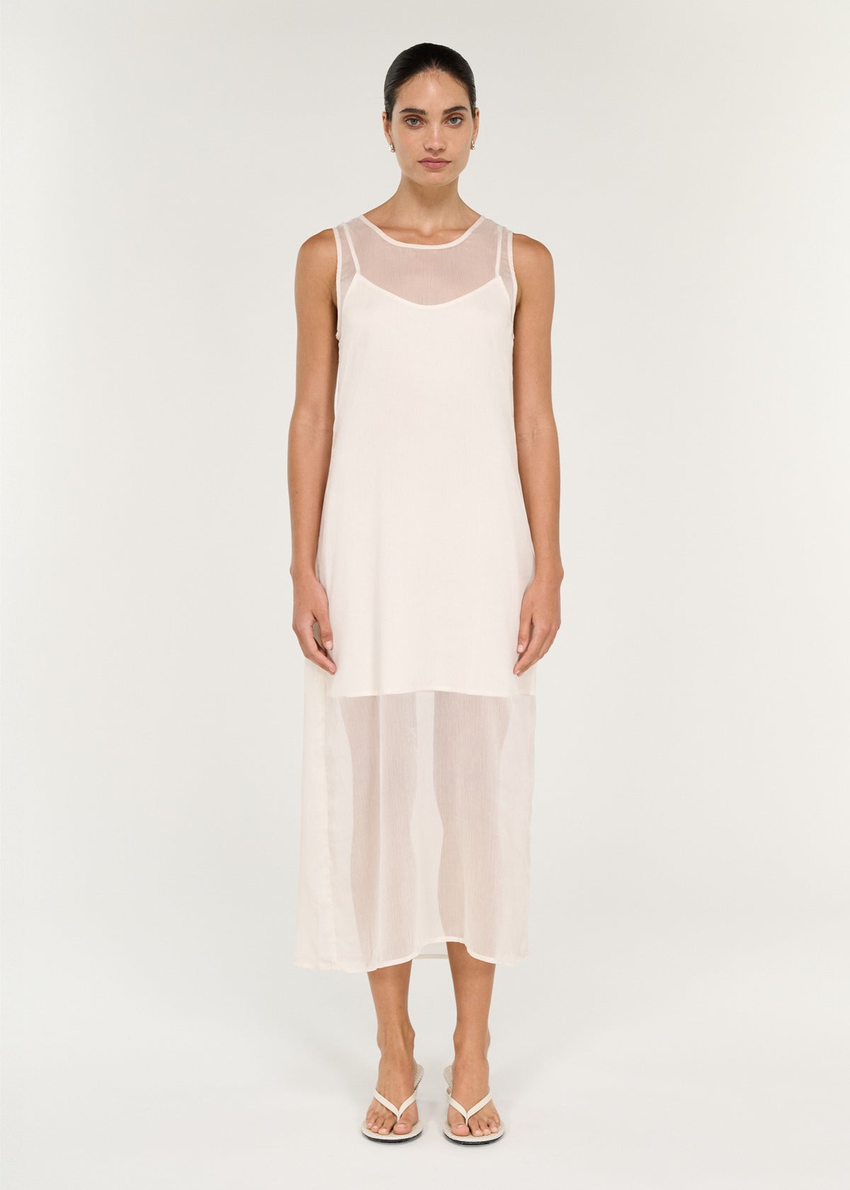 Model wearing Sheer Layered Slip Midi Dress in Cream with a sheer lightweight fabrication and a layered design.