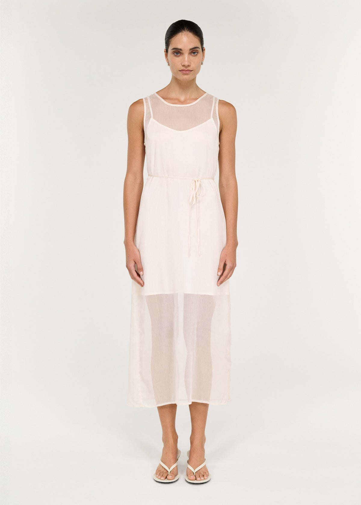 Model wearing Sheer Layered Slip Midi Dress in Cream with a sleeveless cut and a keyhole button closure at back neck.