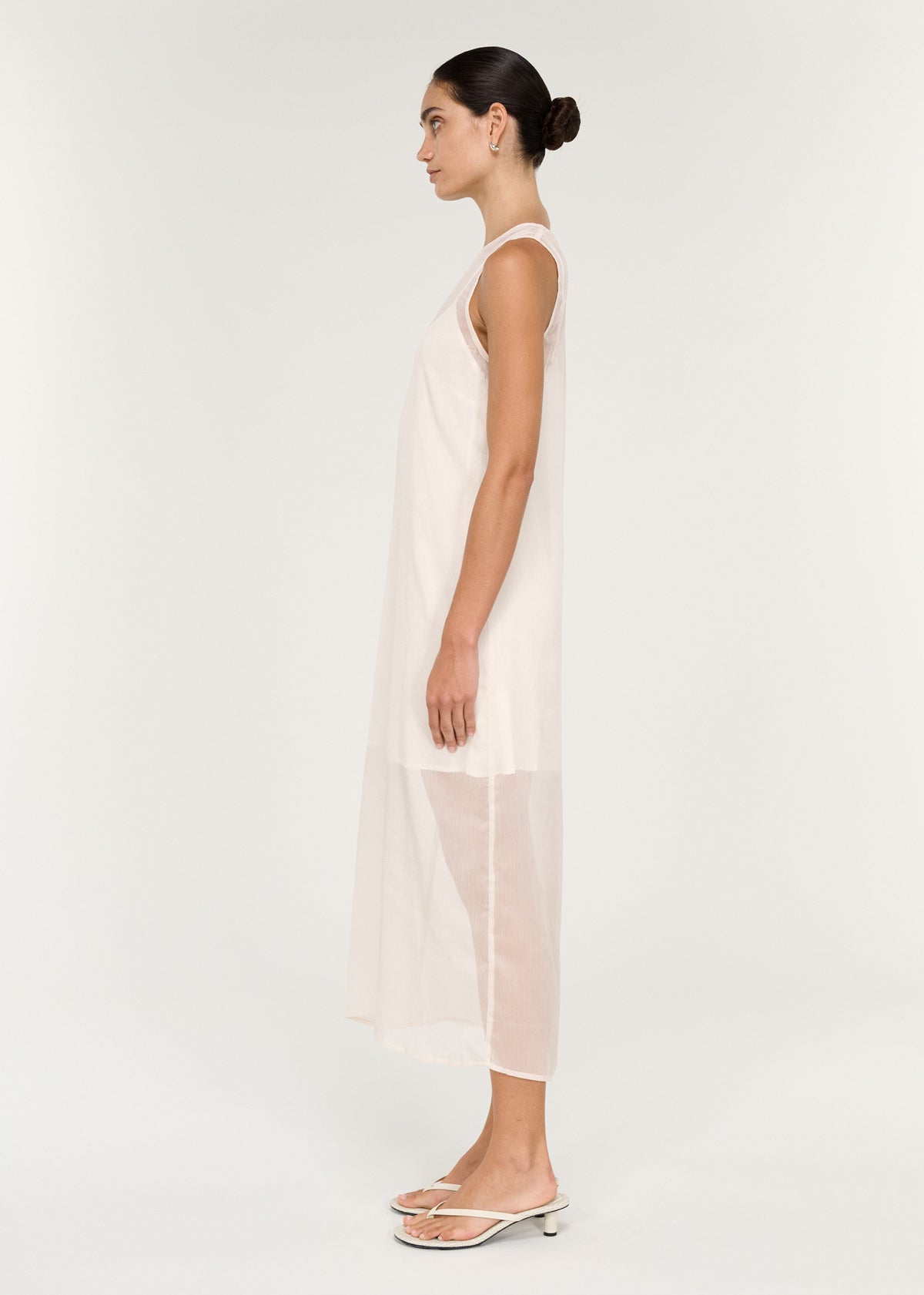 Side view of the Sheer Layered Slip Midi Dress in Cream, showing a sheer lightweight fabrication and a layered design.