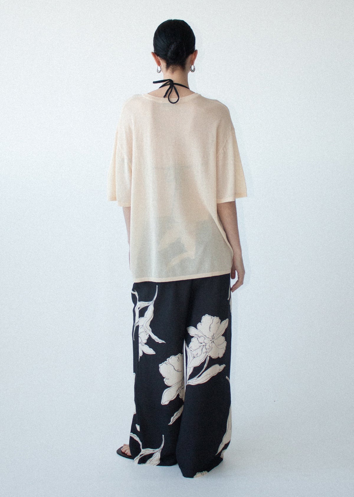 Back view of the Sketched Floral Drawstring Pant with an adjustable drawcord tie and a lightweight woven fabrication.