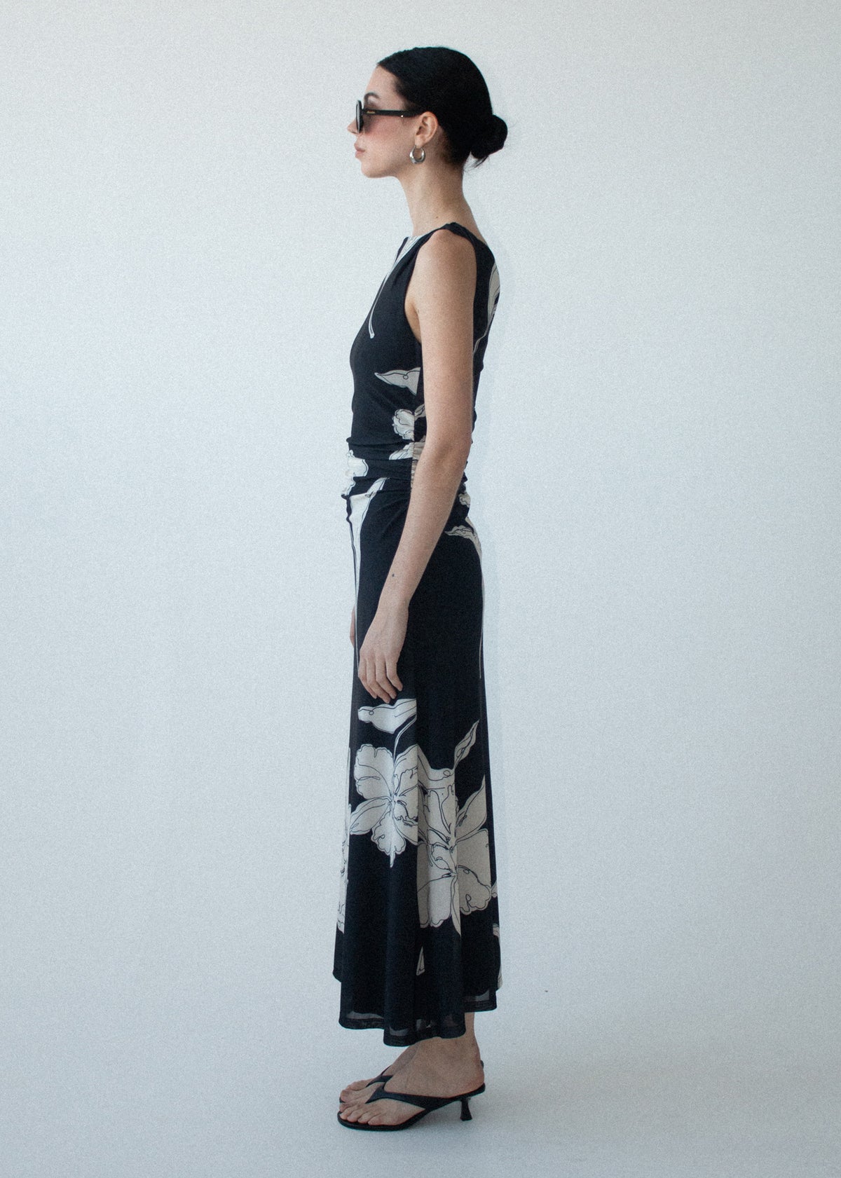 Angled view of the Sketched Floral Mesh Midi Dress with an oversized floral print and a fitted bodice silhouette.