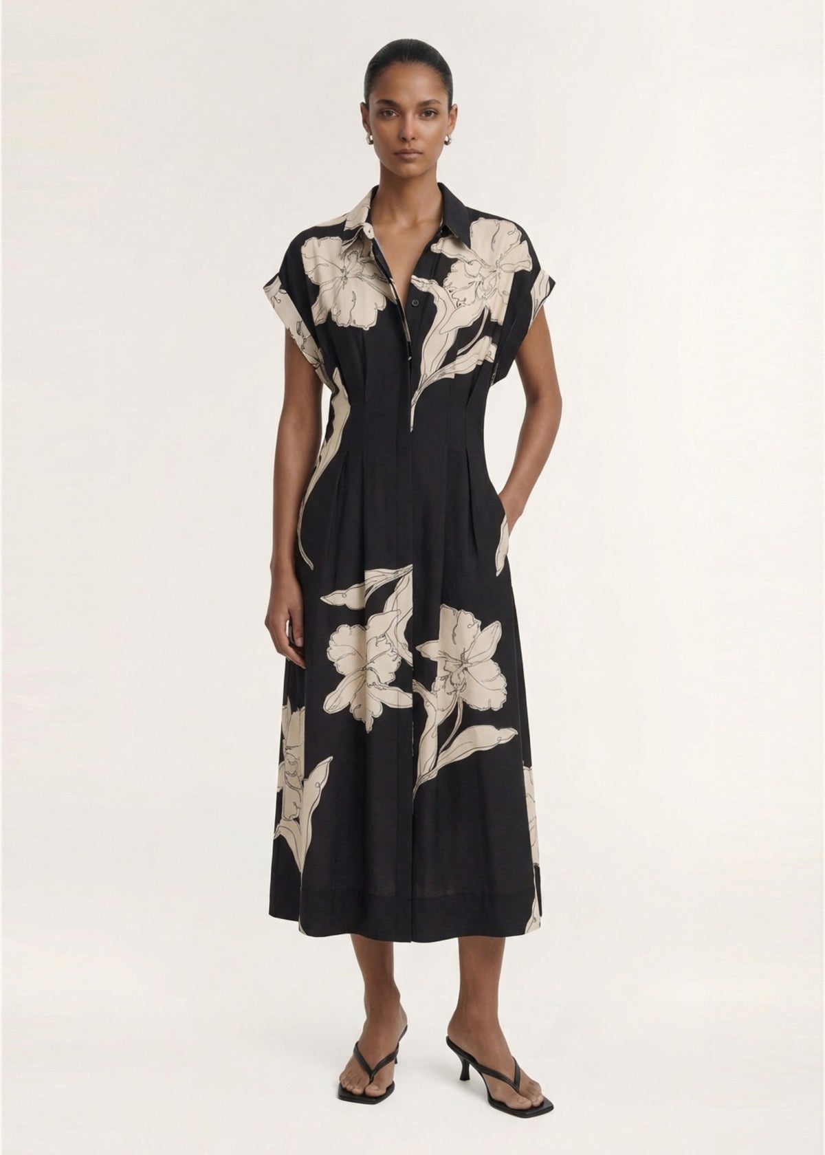 Model wearing Sketched Floral Midi Shirt Dress with a lightweight woven fabrication and an exclusive oversized floral print.