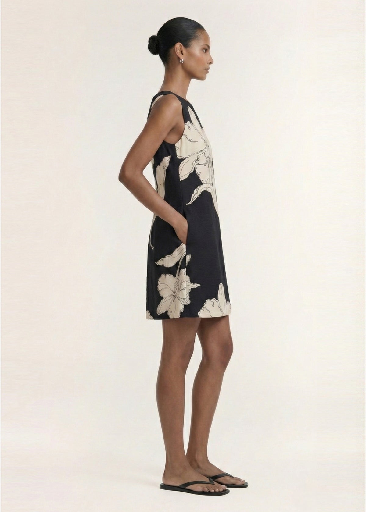 Side view of the Sketched Floral Sleeveless Mini Dress, showing an exclusive oversized floral print and a relaxed shift silhouette.