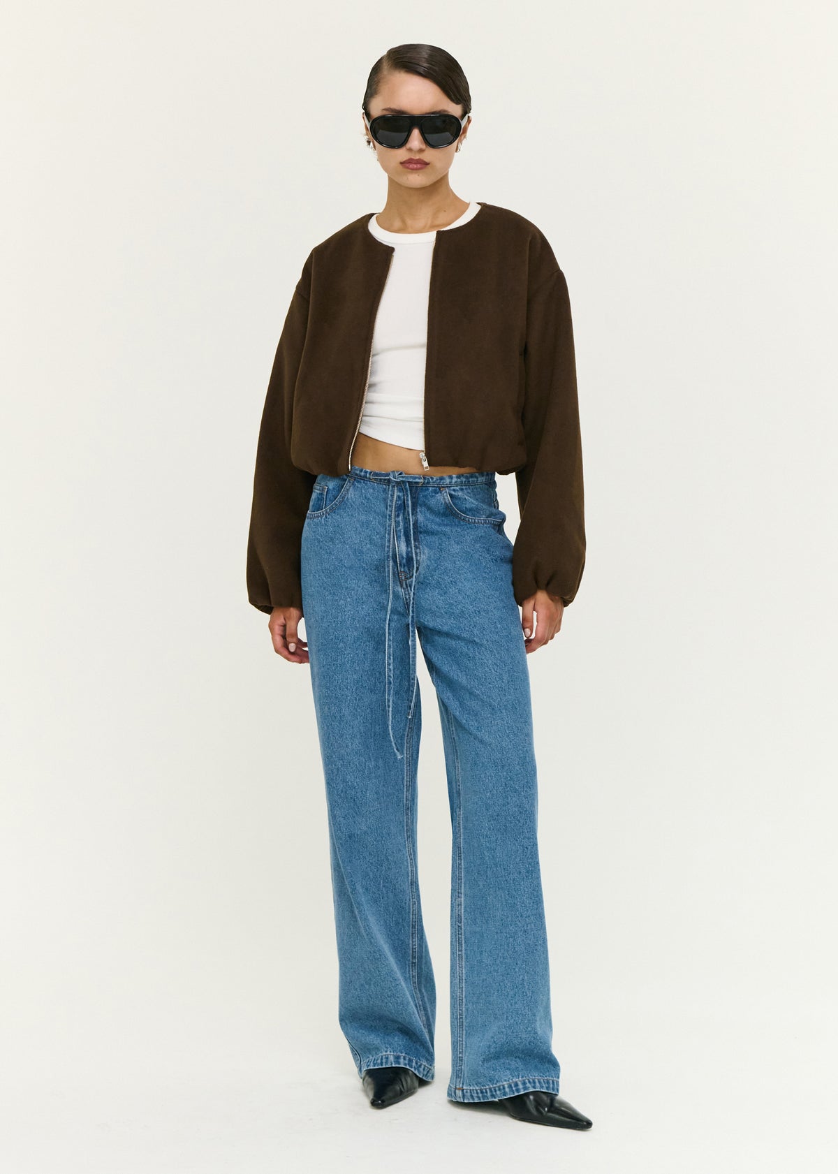 Model wearing Soft Brushed Cropped Bomber Jacket with a front zip closure and a relaxed fit.