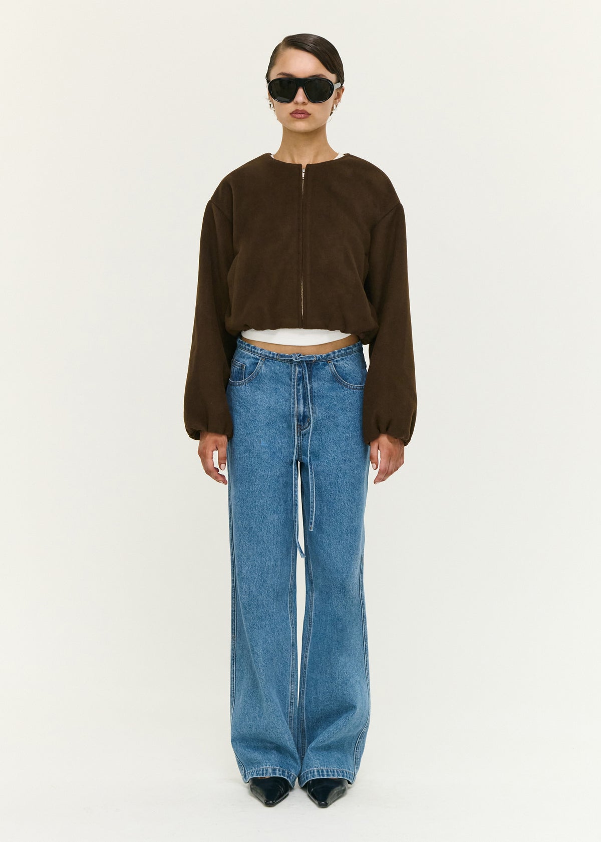 Model wearing Soft Brushed Cropped Bomber Jacket, showing a cropped length and long balloon sleeves with elasticated cuffs.