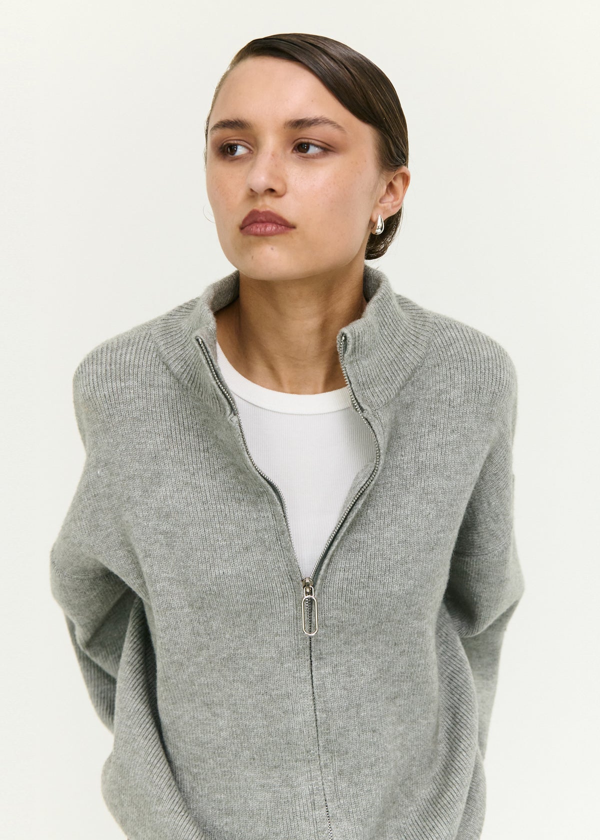 Close-up of the Soft Grey Oversized Zip Cardigan, showing a high neckline and dropped shoulders.