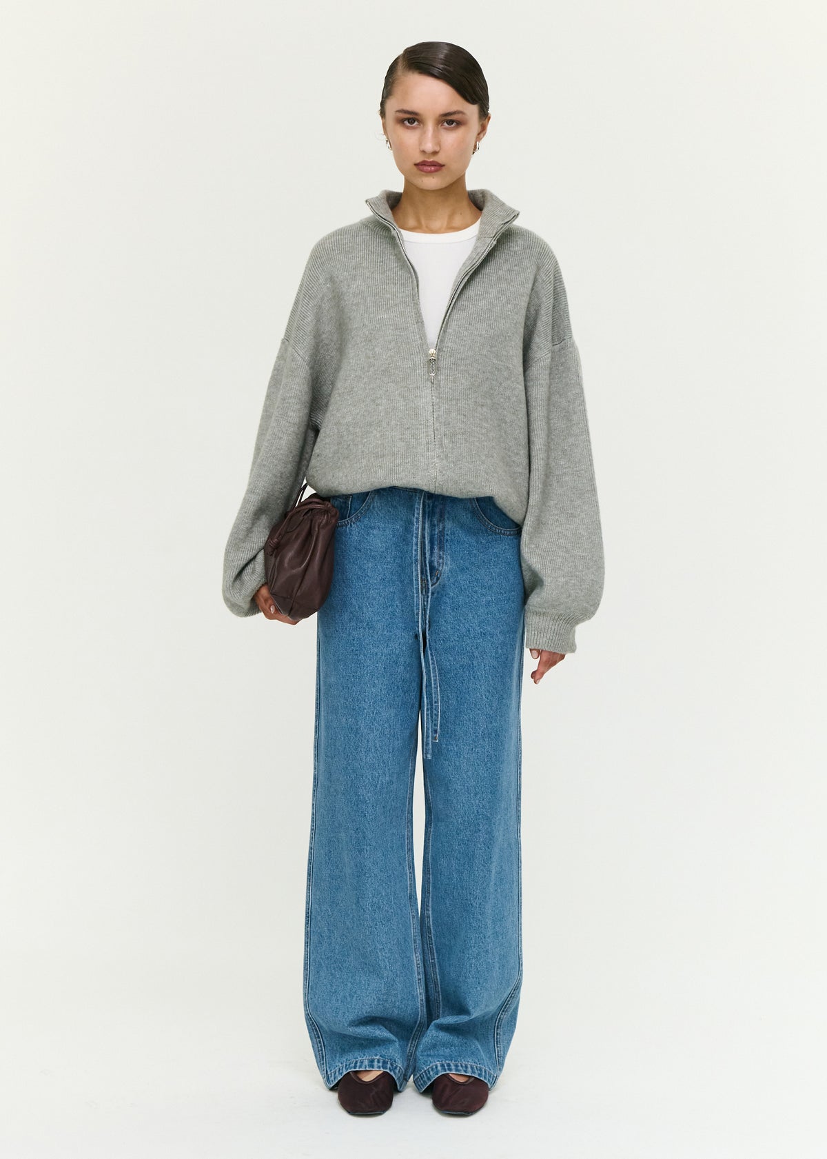 Model wearing Soft Grey Oversized Zip Cardigan with a high neckline and a front zip closure.