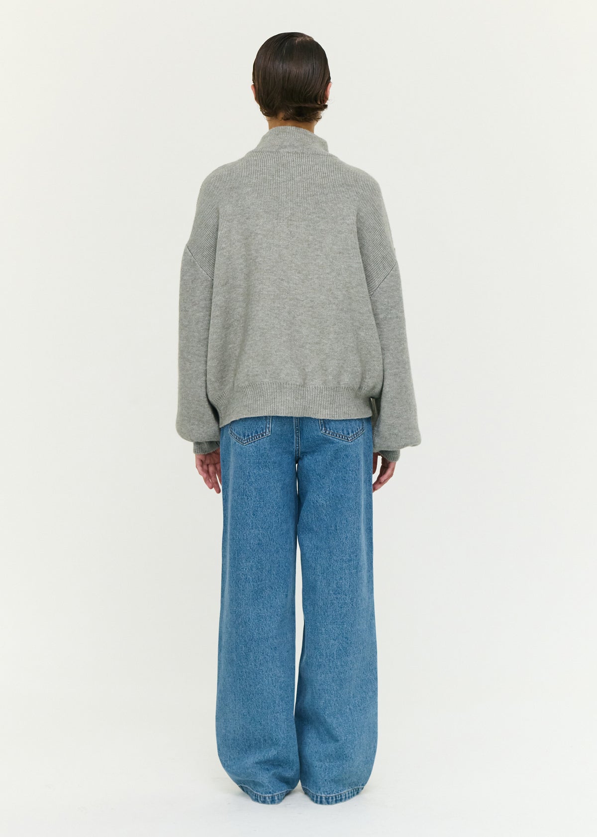 Back view of the Soft Grey Oversized Zip Cardigan with a front zip closure and a soft ribbed knit fabrication.