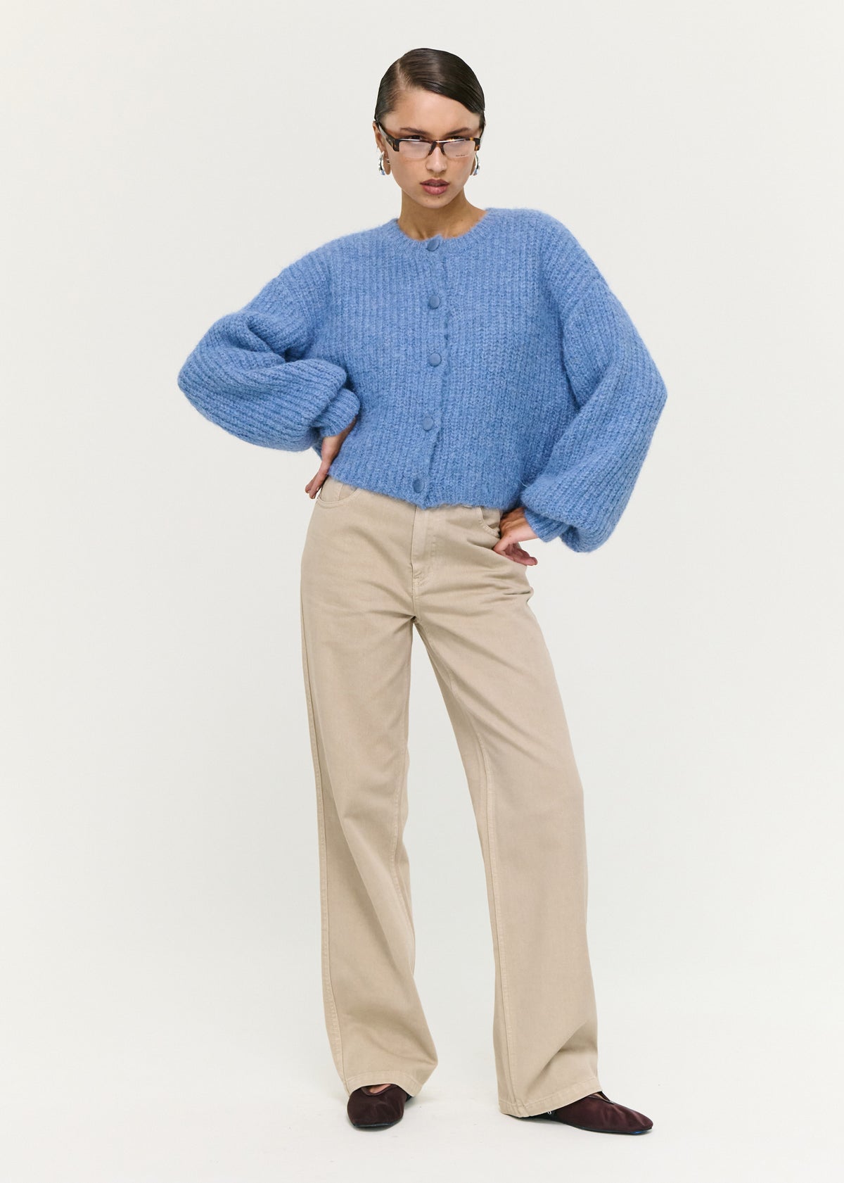 Model wearing Soft Handle Balloon Sleeve Cardigan in Blue, showing long sleeves with ribbed cuffs and a slight cropped length.