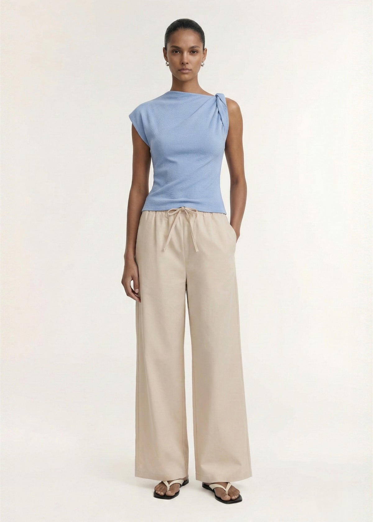 Model wearing Stone Cotton Wide Leg Drawstring Pant with a lightweight woven fabrication and an elasticated drawstring waist.