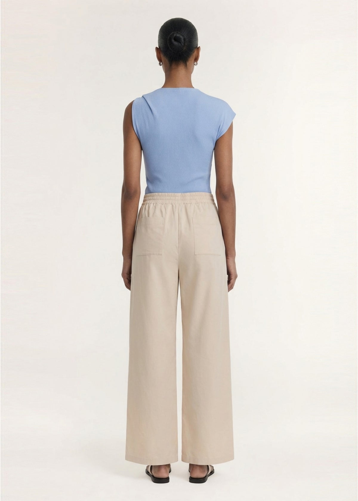 Back view of the Stone Cotton Wide Leg Drawstring Pant with back patch pockets and a lightweight woven fabrication.