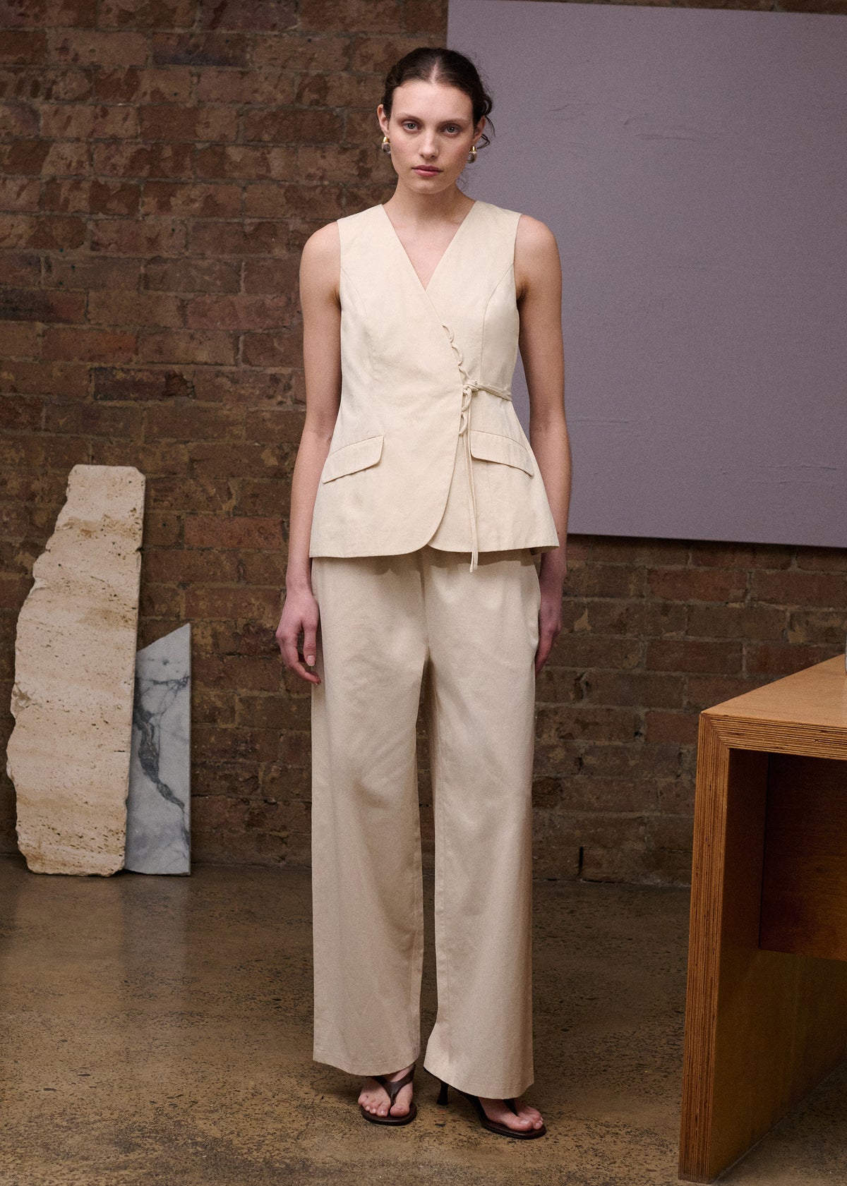 Model wearing Stone Cotton Wide Leg Drawstring Pant, showing a wide-leg silhouette and side pockets.