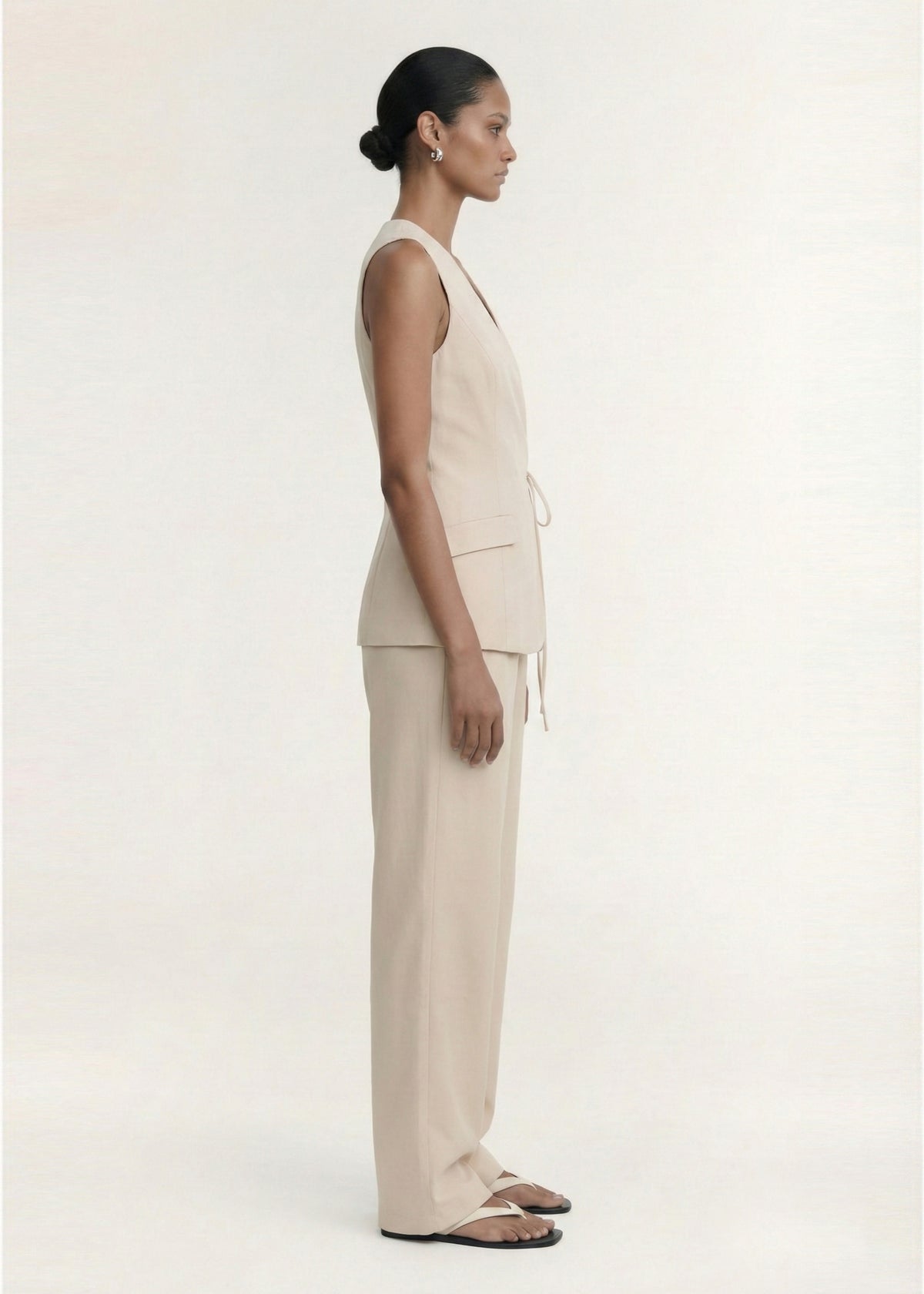 Side profile of the Stone Cotton Wide Leg Drawstring Pant with a wide-leg silhouette and side pockets.