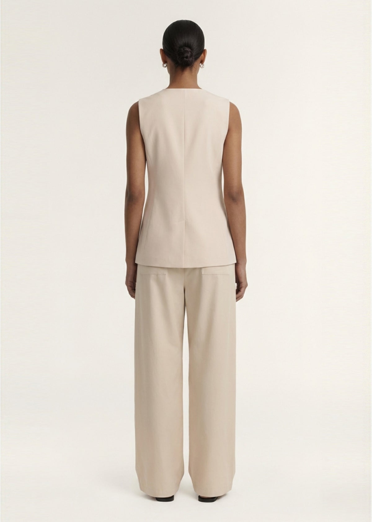 Back view of the Stone Cotton Wide Leg Drawstring Pant, showing back patch pockets and a lightweight woven fabrication.