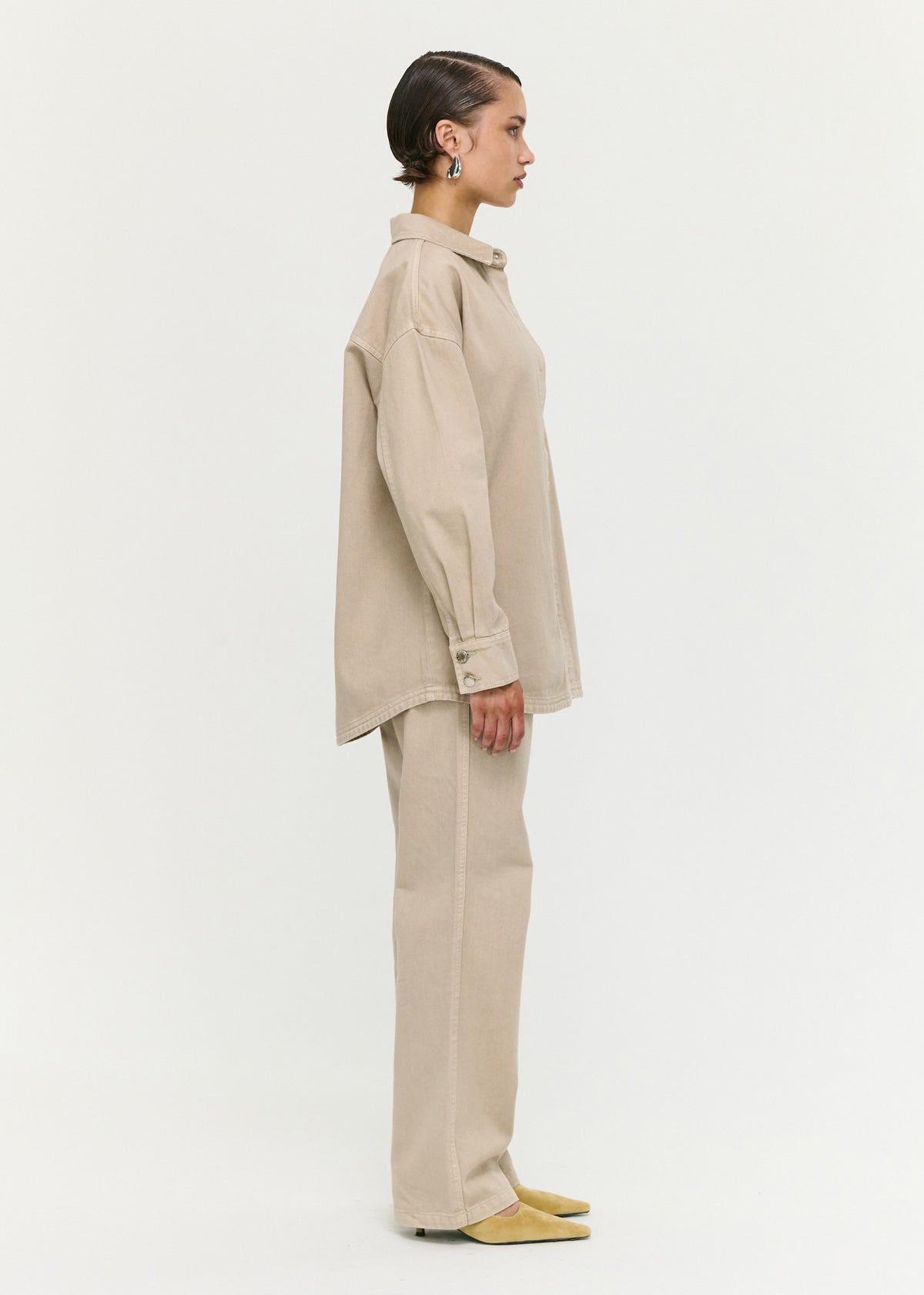 Side view of the Stone Wash Relaxed Denim Shacket, showing a relaxed oversized fit and a button-through front.