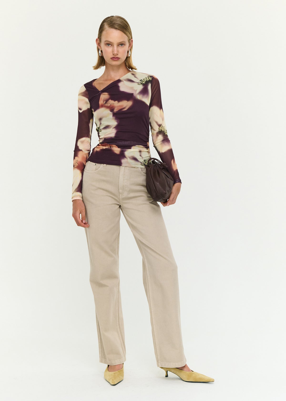 Model wearing Stone Wash Straight Leg Jeans with a high rise fit and a straight leg silhouette.
