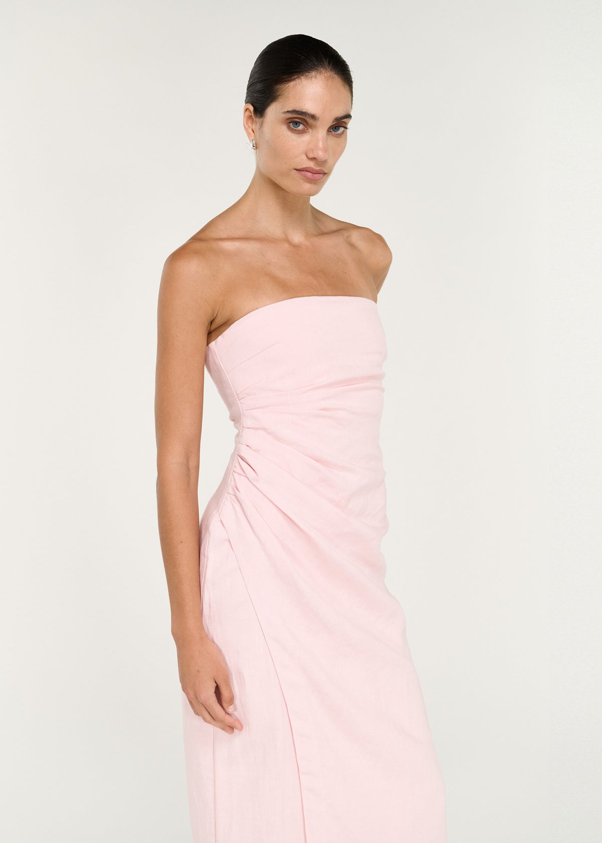 Close-up of the Strapless Wrap Midi Dress in Soft Pink, showing a strapless silhouette and a straight neckline.