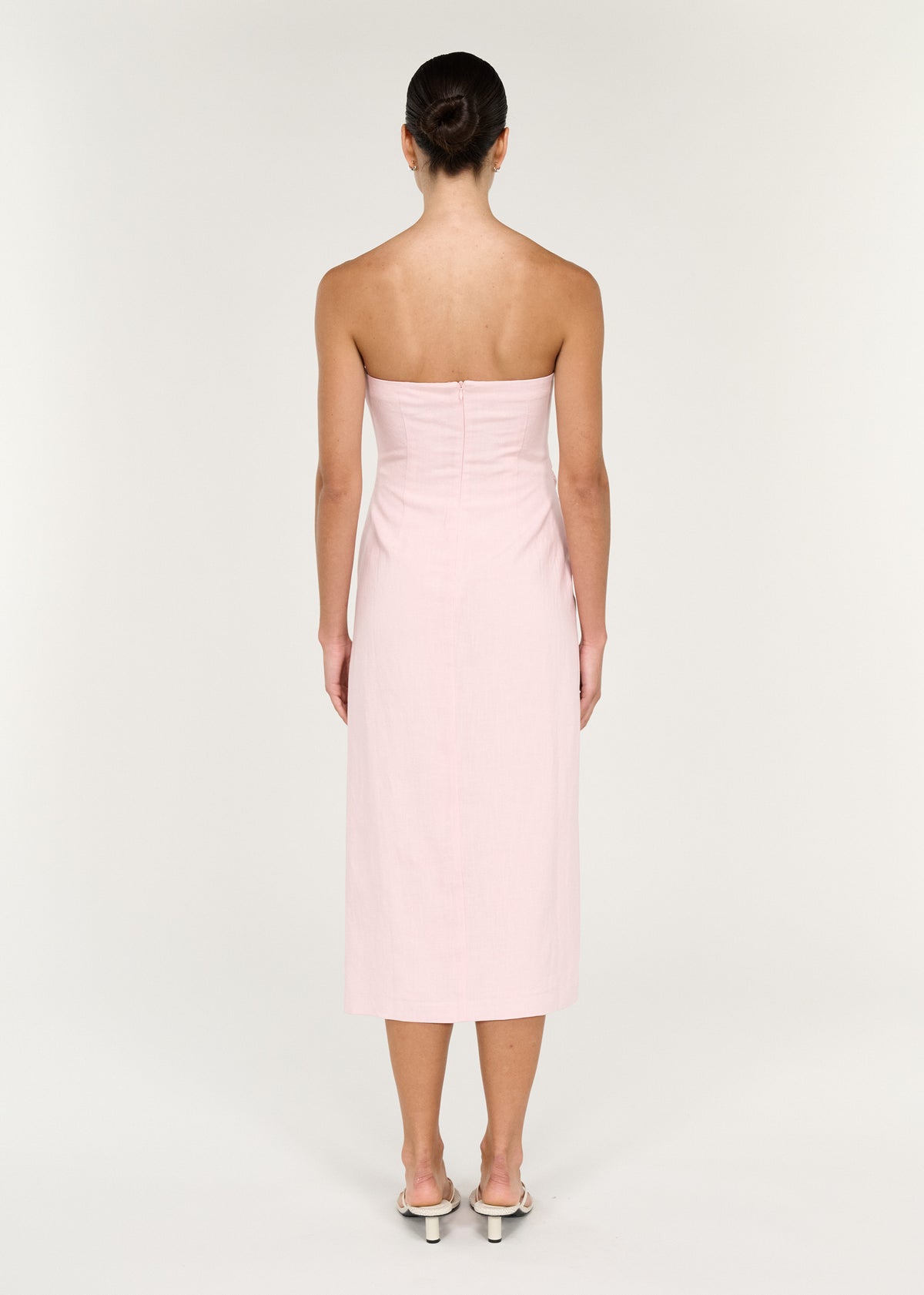 Back view of the Strapless Wrap Midi Dress in Soft Pink with a strapless silhouette and a centre back zip closure.