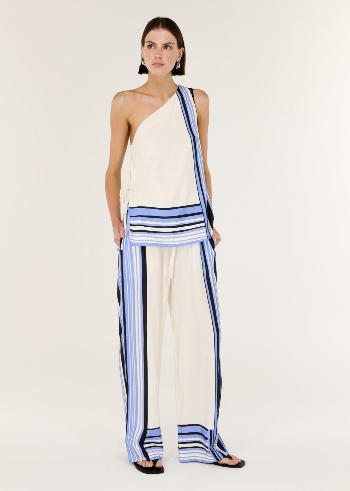 Model wearing Stripe Relaxed Wide-Leg Low Rise Pants with a relaxed wide-leg silhouette and a comfortable pull-on waist.