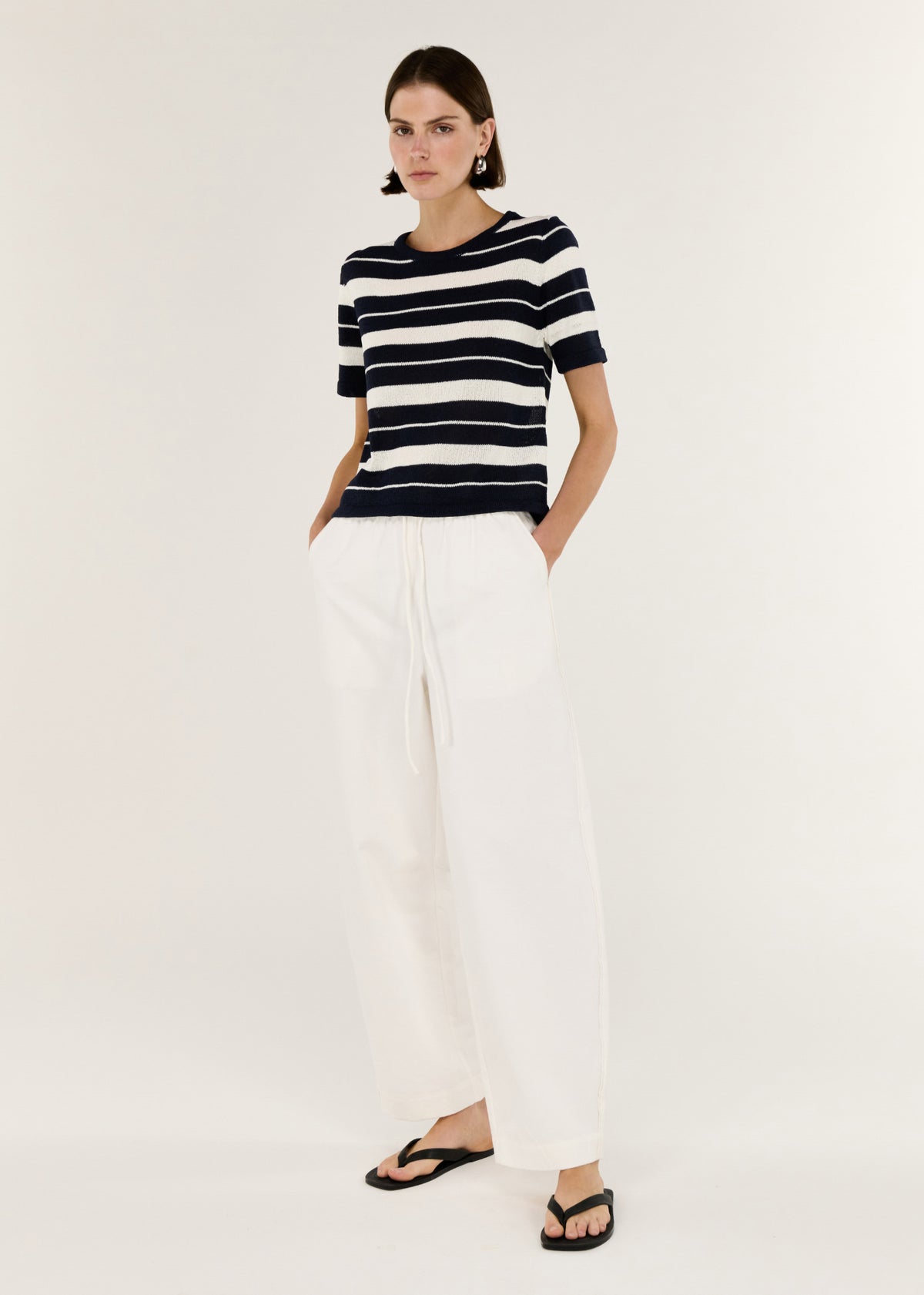 Model wearing Striped Crew Neck Knit Tee, showing a relaxed, easy fit and short sleeves.