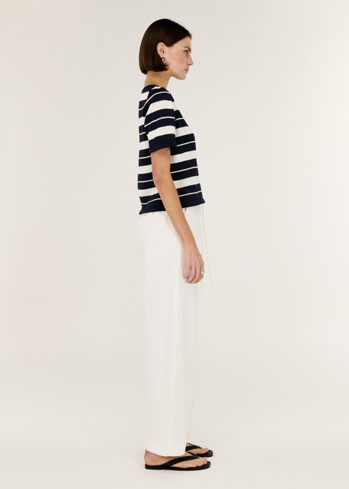 Side view of the Striped Crew Neck Knit Tee, showing a classic crew neckline and a timeless stripe design.