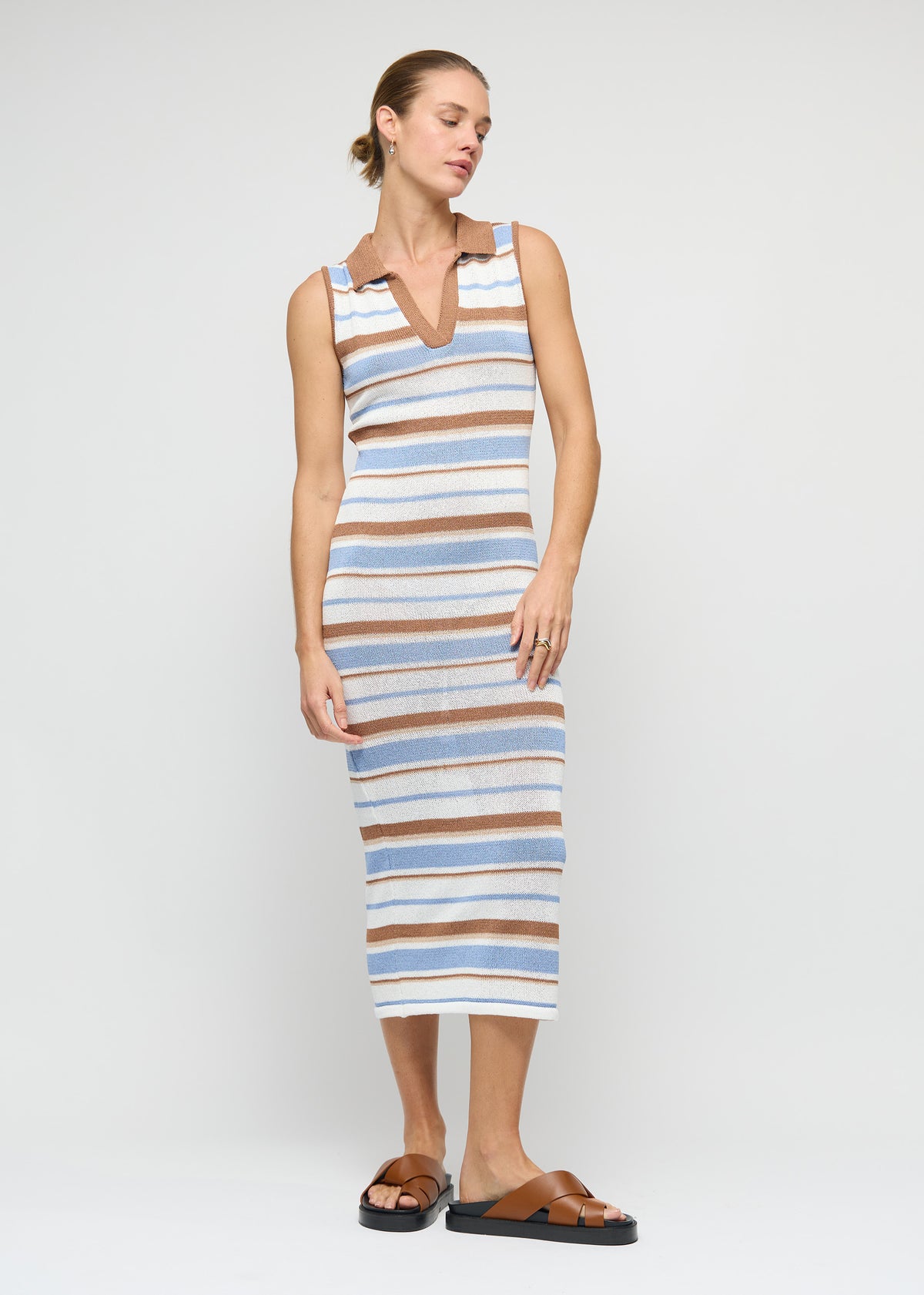 Model wearing Striped Knit Midi Dress with a sleeveless fitted midi silhouette and a contrast collar with V-neckline.