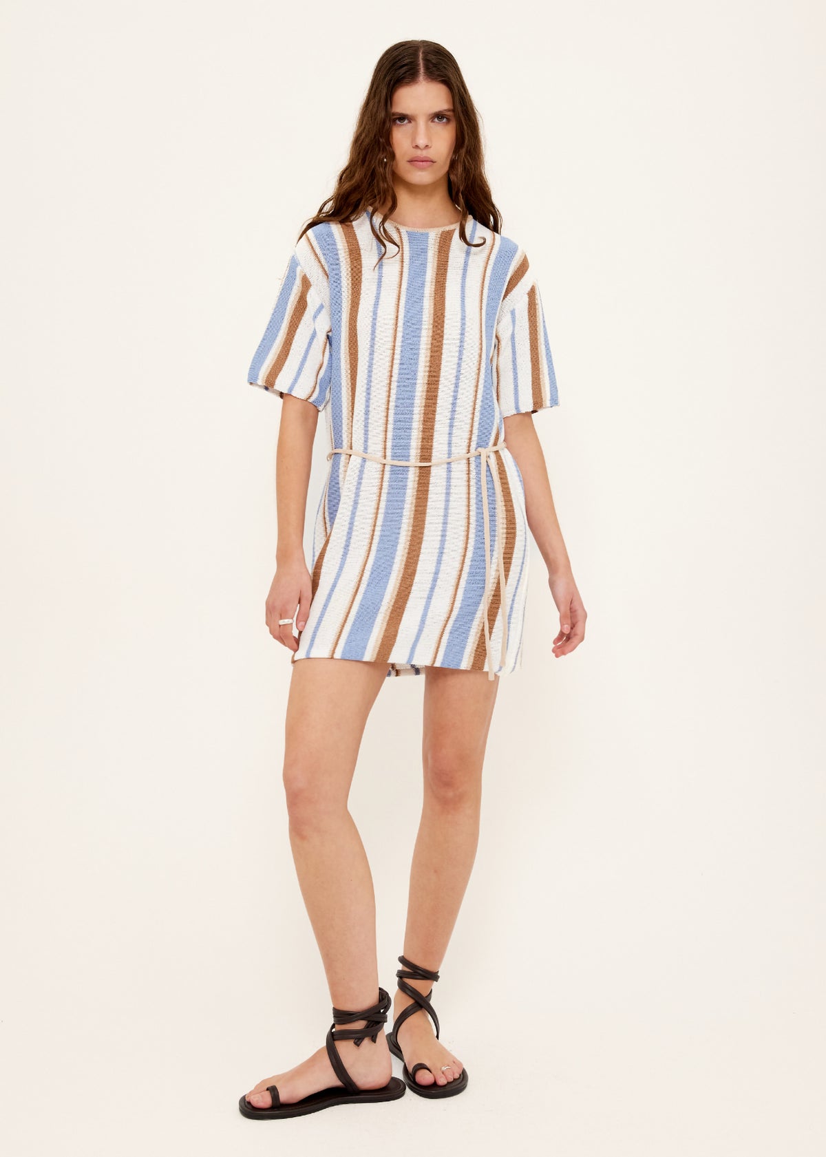 Model wearing Striped Knit T-Shirt Mini Dress with a relaxed T-shirt silhouette and a removable waist tie.