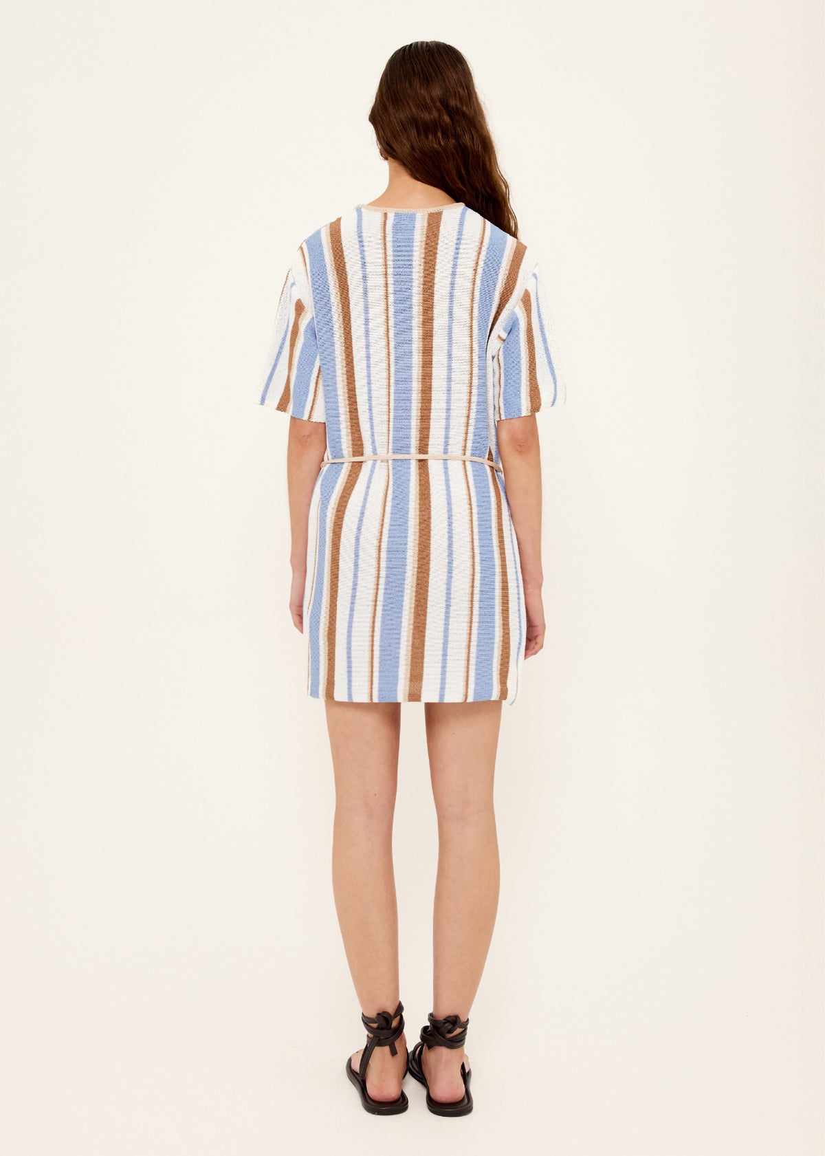 Back view of the Striped Knit T-Shirt Mini Dress with a removable waist tie and a relaxed T-shirt silhouette.