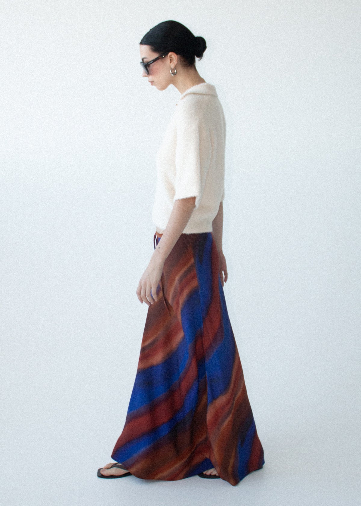 Side view of the Sunset Ombre Print Bias Maxi Skirt, showing a lightweight sheer fabrication and an exclusive abstract ombre print.