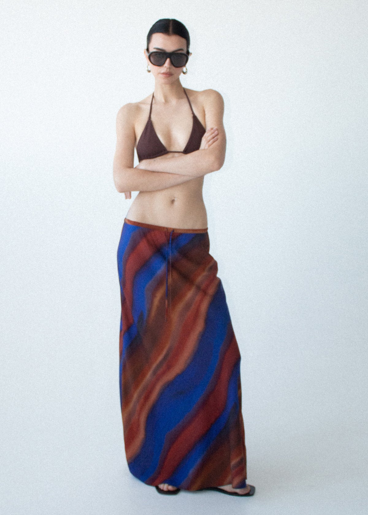 Model wearing Sunset Ombre Print Bias Maxi Skirt with a softly flared A-line shape and a maxi length.