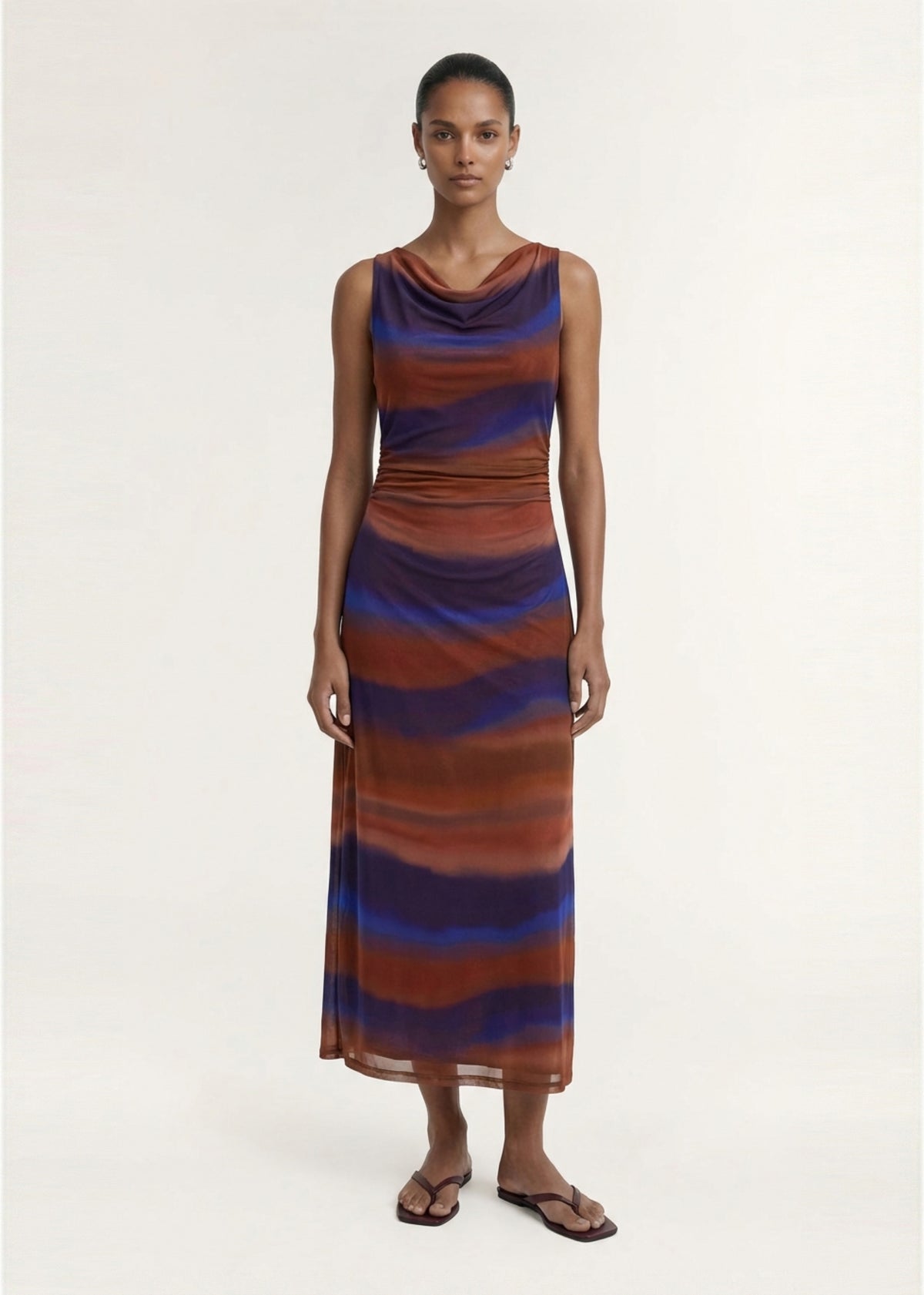 Model wearing Sunset Ombre Print Sleeveless Mesh Midi Dress with a soft stretch mesh fabrication and an exclusive abstract ombre print.
