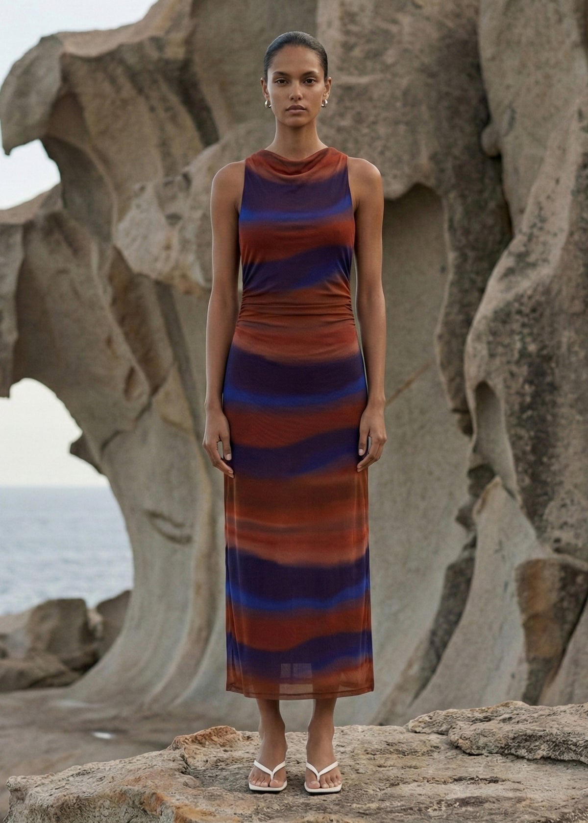 Model wearing Sunset Ombre Print Sleeveless Mesh Midi Dress, showing a body-skimming silhouette and a high round neckline.