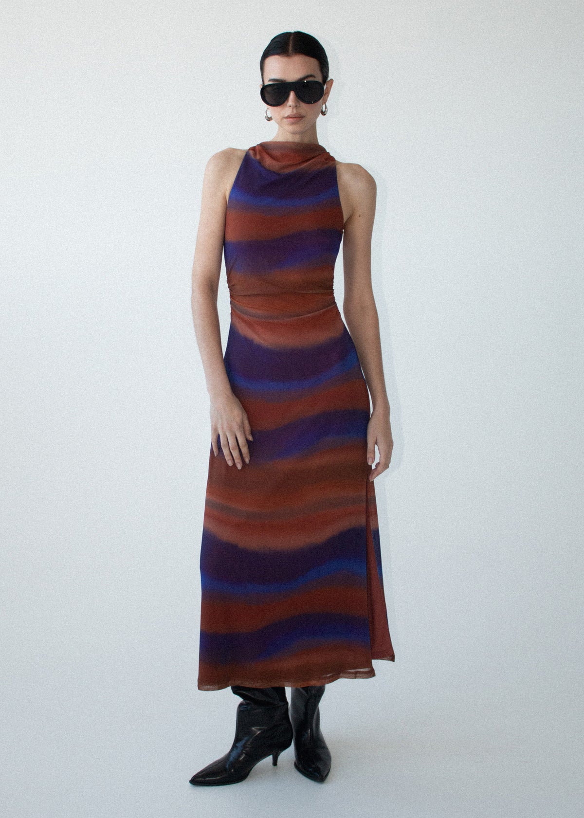 Model wearing Sunset Ombre Print Sleeveless Mesh Midi Dress, showing an exclusive abstract ombre print and a body-skimming silhouette.