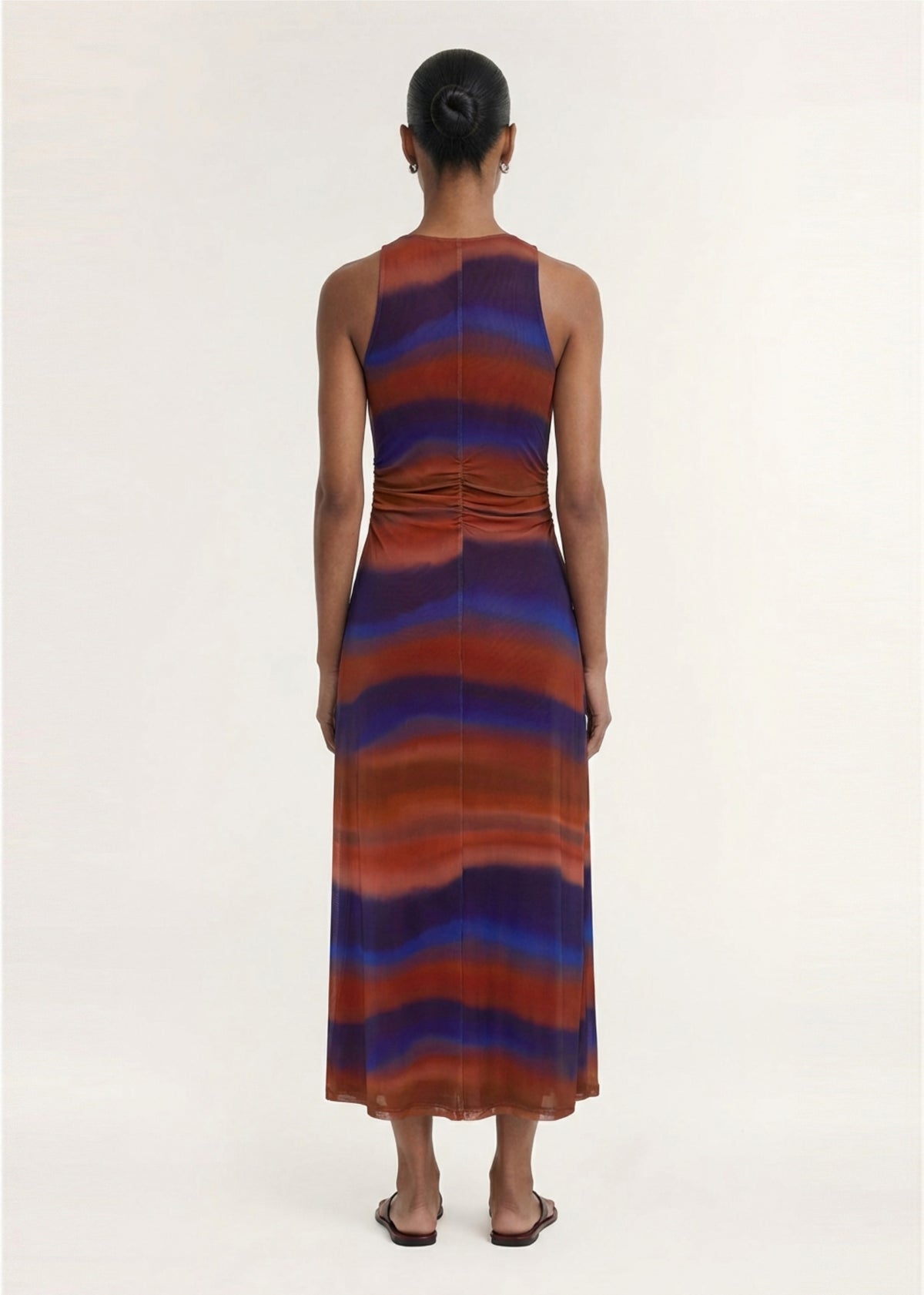 Back view of the Sunset Ombre Print Sleeveless Mesh Midi Dress with a soft stretch mesh fabrication and an exclusive abstract ombre print.