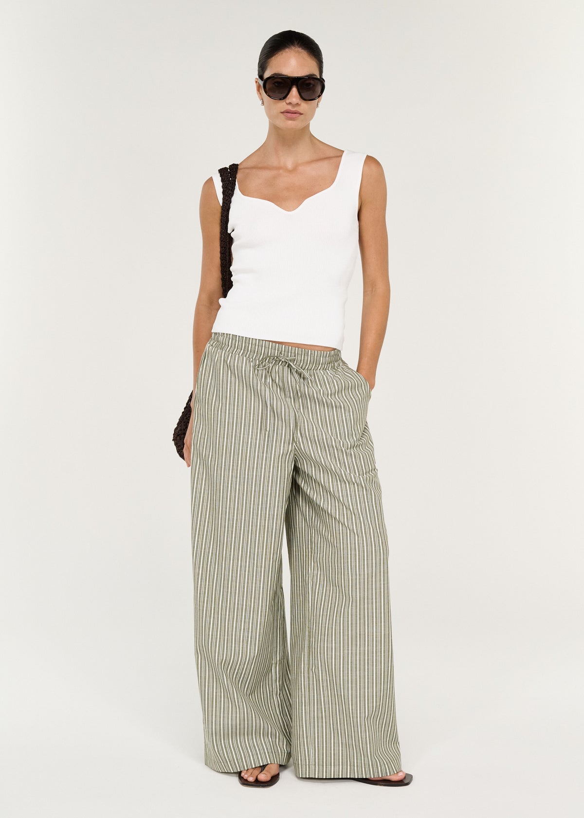 Model wearing Sweetheart Rib Knit Tank in White with a soft ribbed knit fabrication and a fitted silhouette.