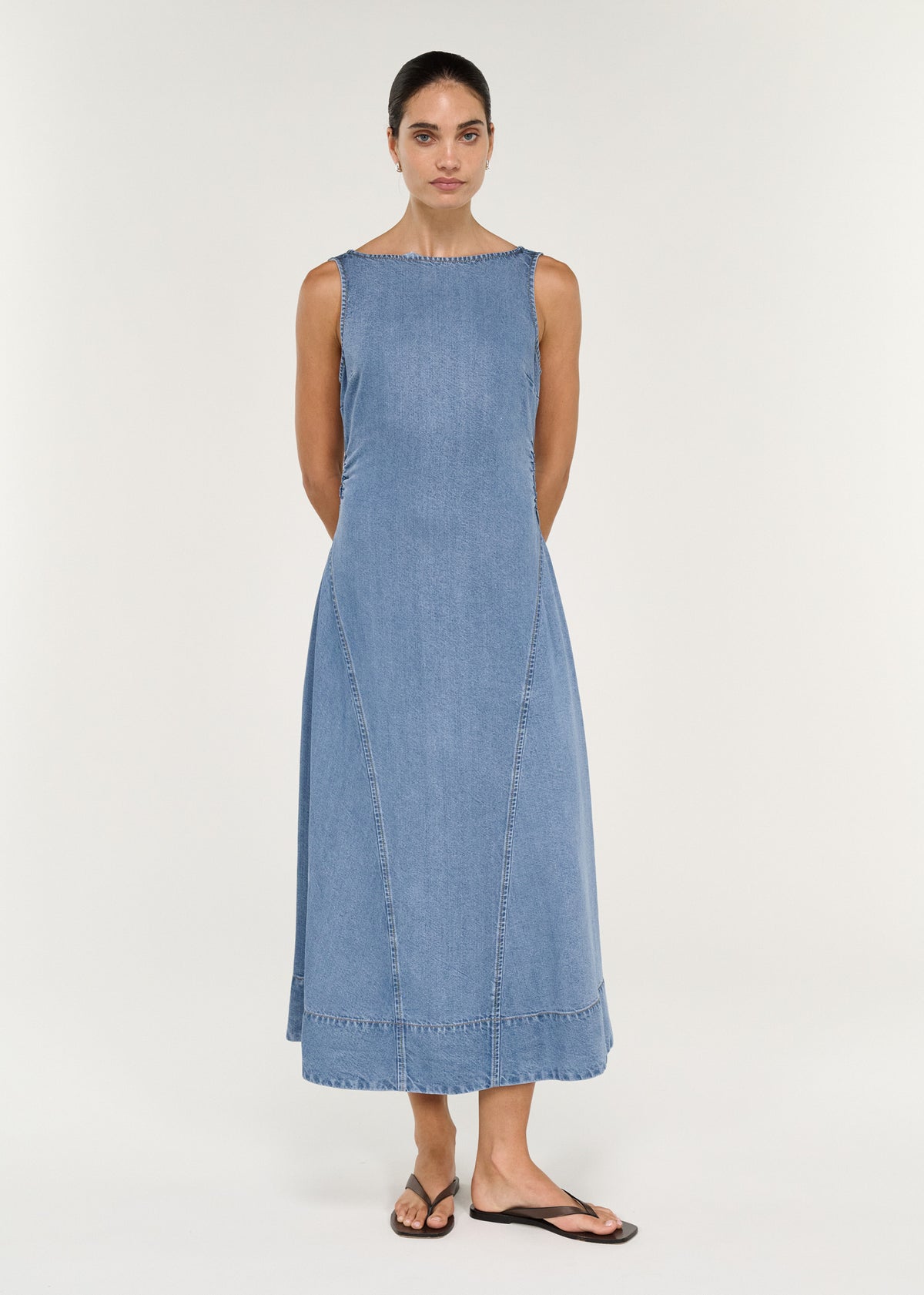 Chambray Denim Sleeveless Midi Dress featuring a fitted bodice and A-line skirt against a neutral background.