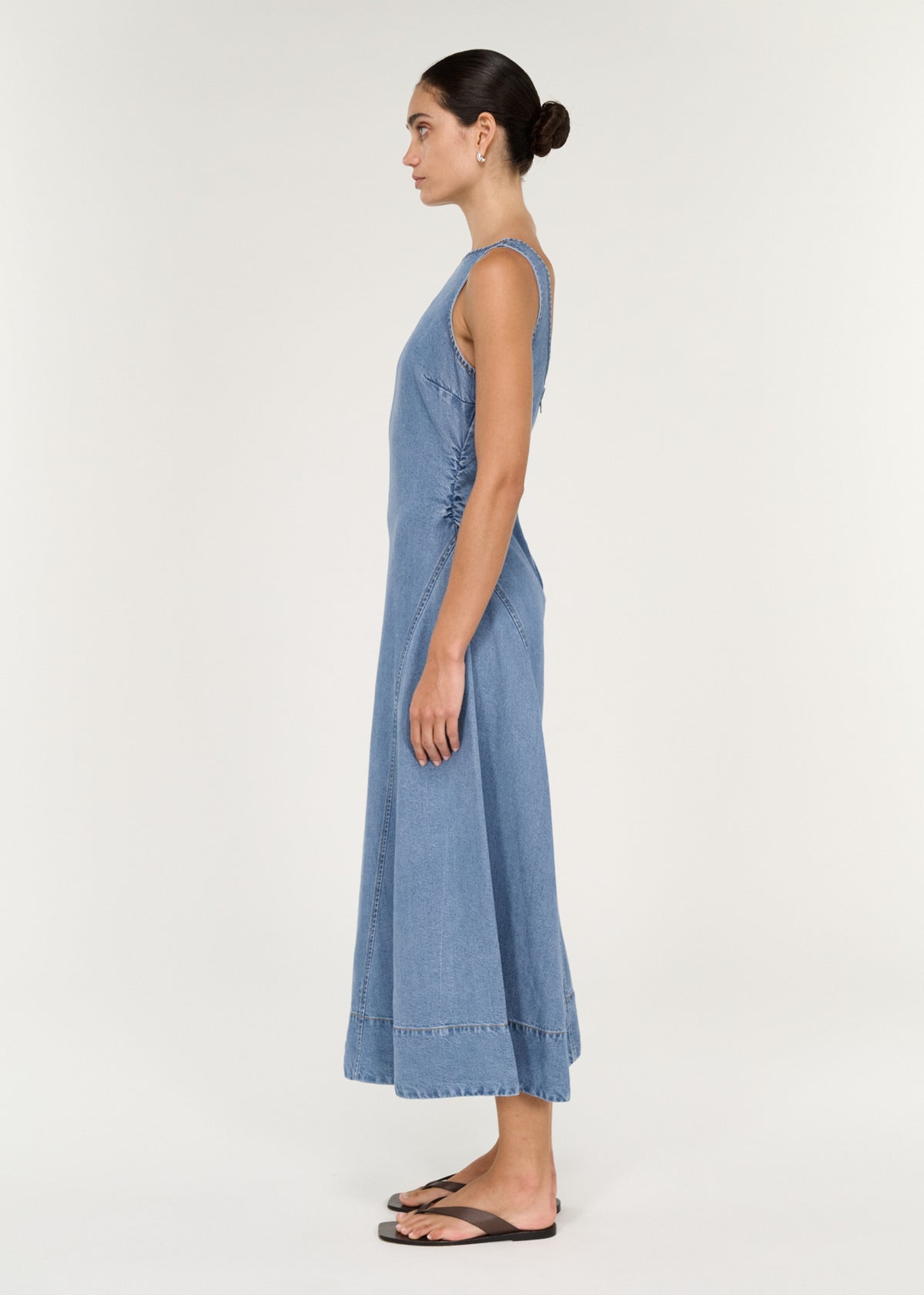 Chambray Denim Sleeveless Midi Dress side view showcasing fitted bodice and A-line skirt.